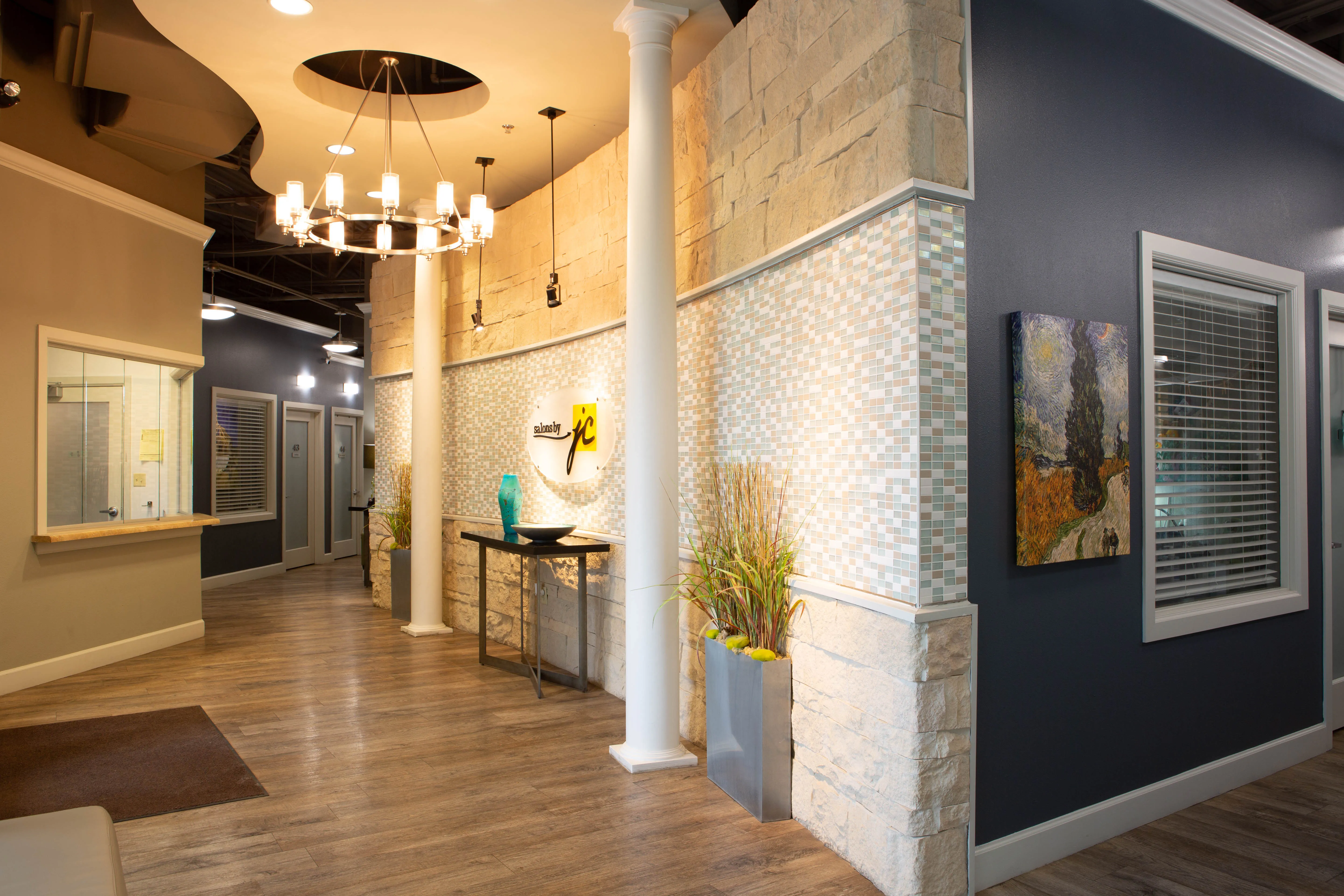 Modern salon suite waiting area at a Salons by JC location, demonstrating the professional environment franchise owners offer to stylists