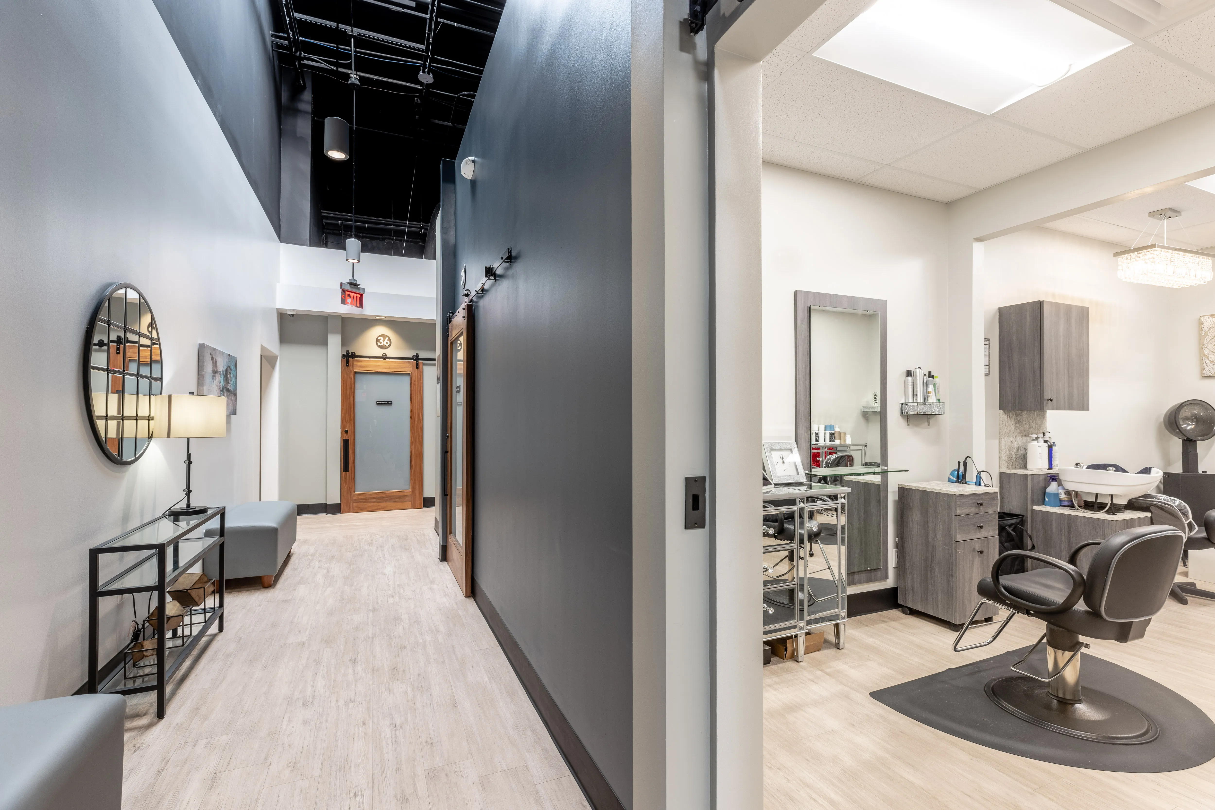 Modern private salon suite at Salons by JC with styling chair, mirror, and professional lighting