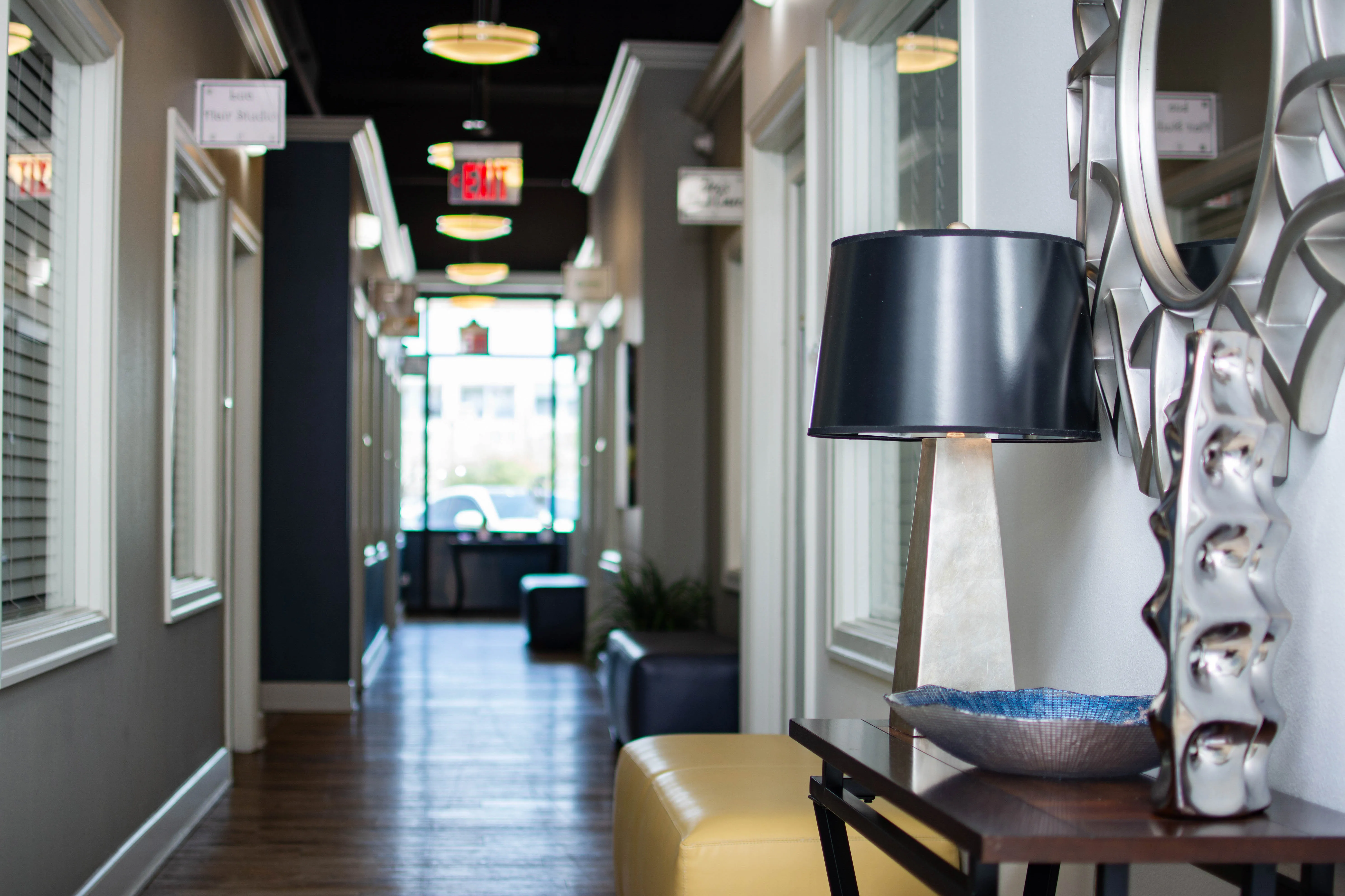 Bright salon suite interior at a Salons by JC franchise location with a styling chair
