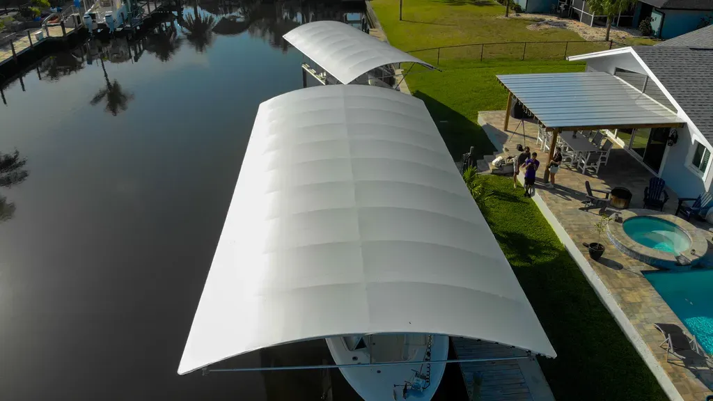 Boat lift canopy installed over a pontoon at a Southwest Florida waterfront dock