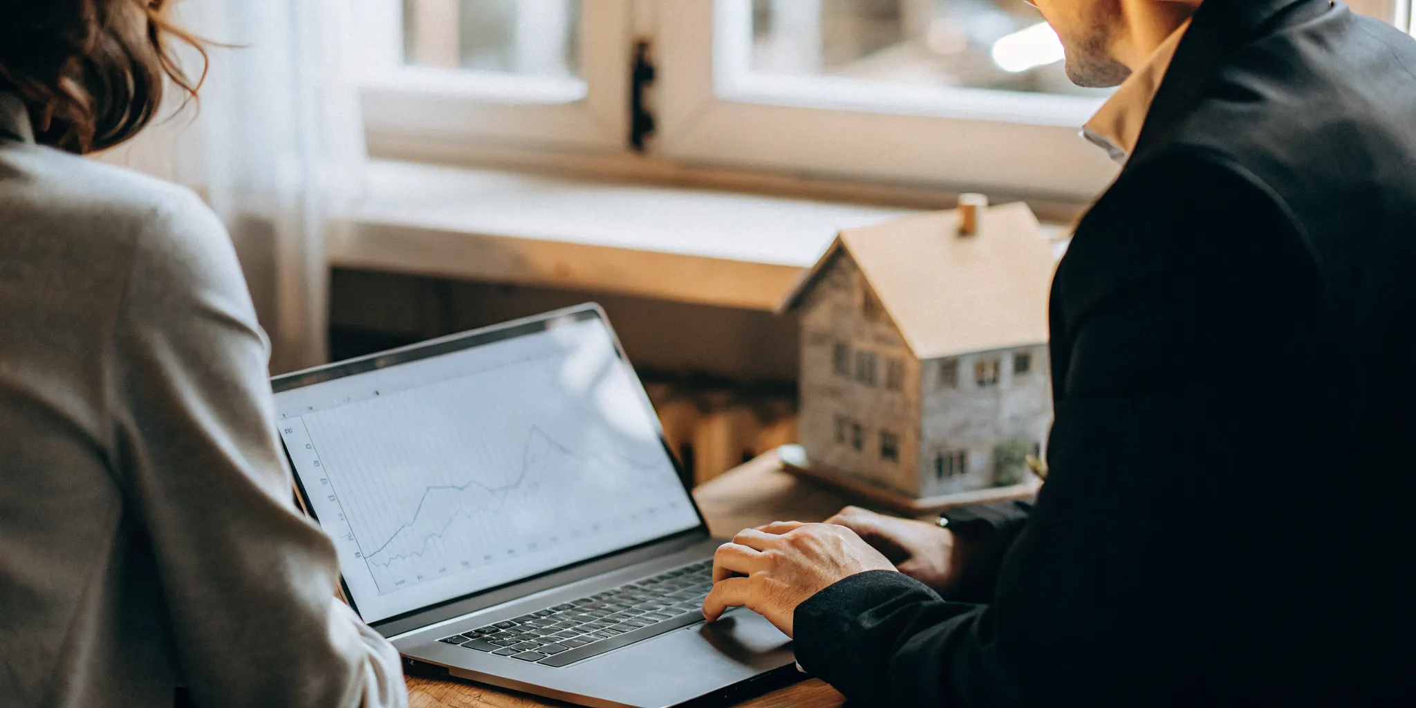 Mortgage advisor reviewing rental income figures with a real estate investor at a desk