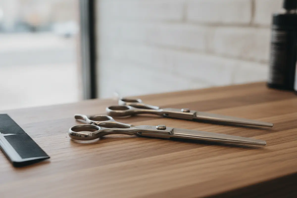 Professional barber shears with offset and straight handles arranged for a side-by-side fit comparison