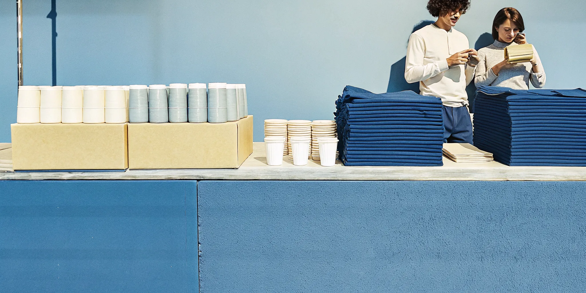 Team organizing branded merchandise for an employee company store