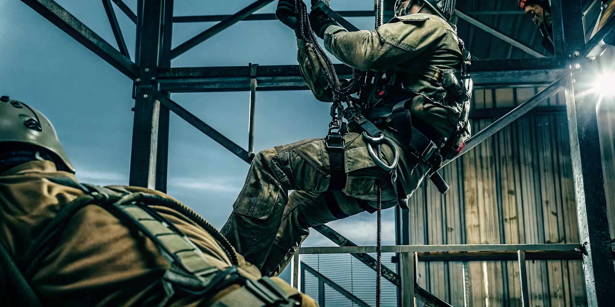 Tactical operator using a rappelling harness during controlled descent
