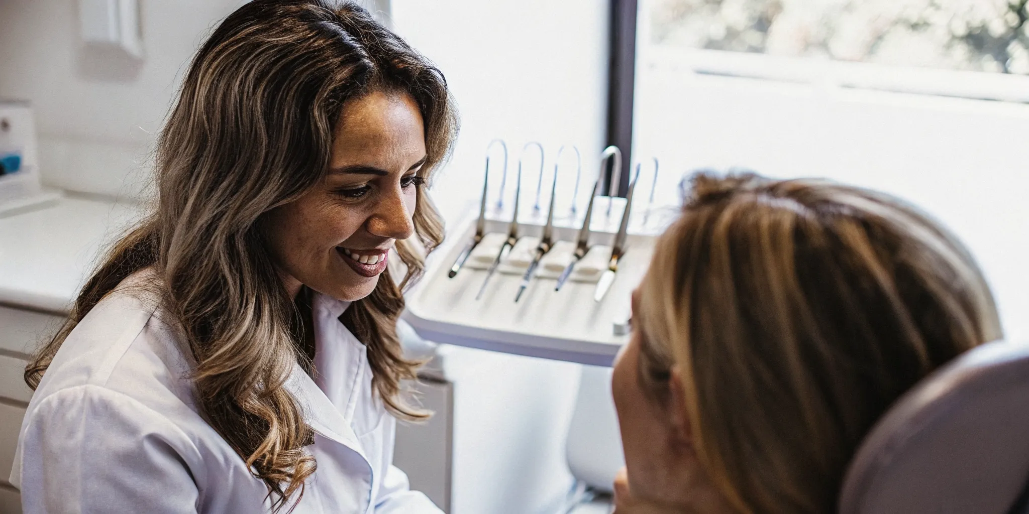 Dental hygienist discussing a preventive dental cleaning and exam with a patient