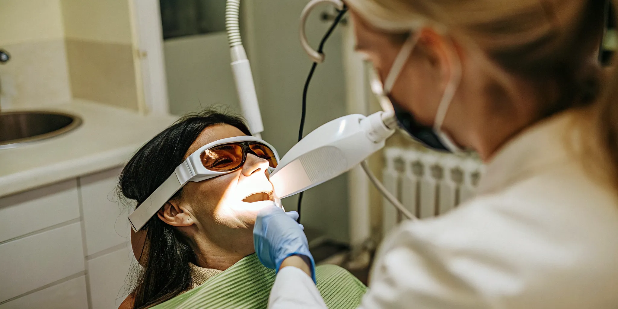 Professional Zoom teeth whitening treatment in progress at a cosmetic dentist office