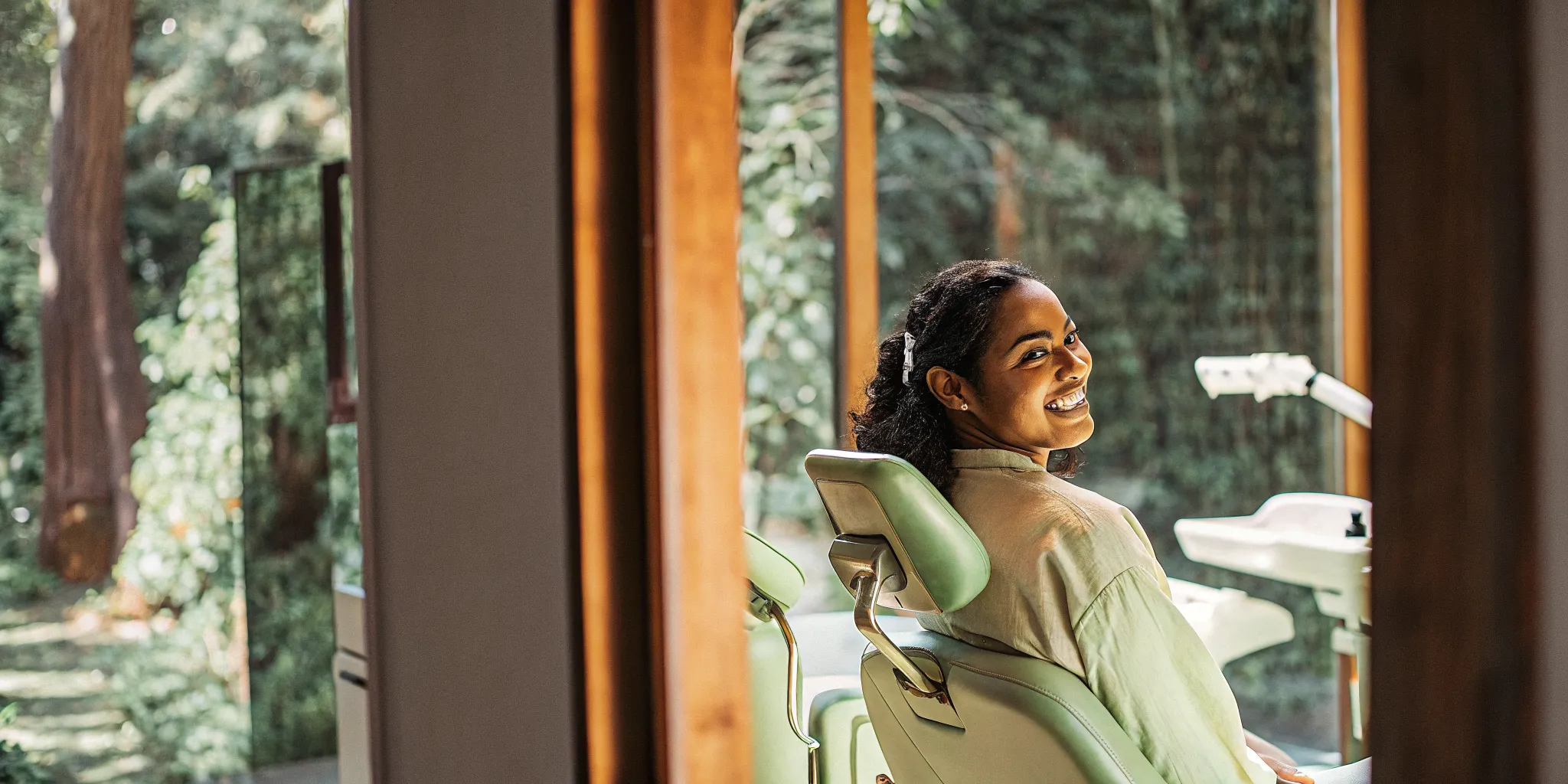 Confident dental patient smiling in a modern dental office waiting room setting