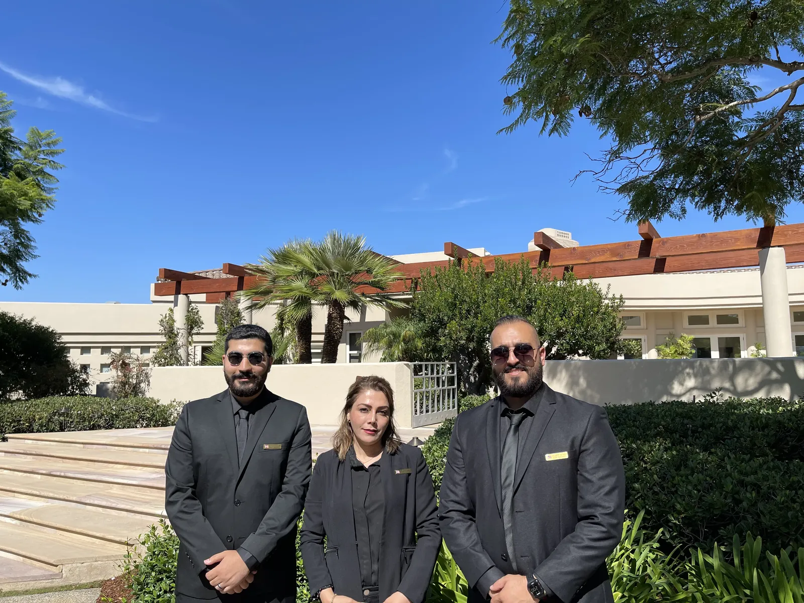 Business security team discussing executive protection outside a corporate facility