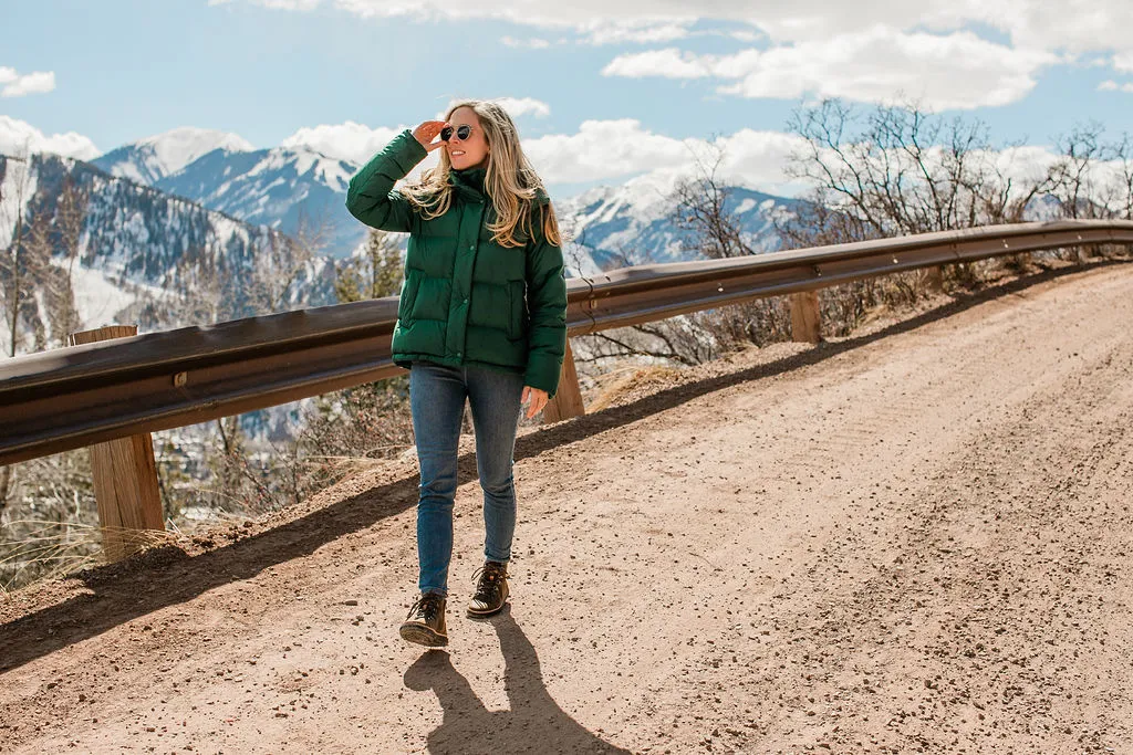 A woman wearing boots outdoors on a mountain trail