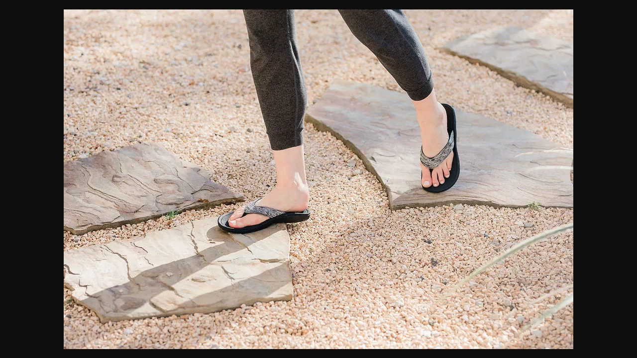 Woman wearing Harmony 783 grounding sandals during a calm evening wellness routine