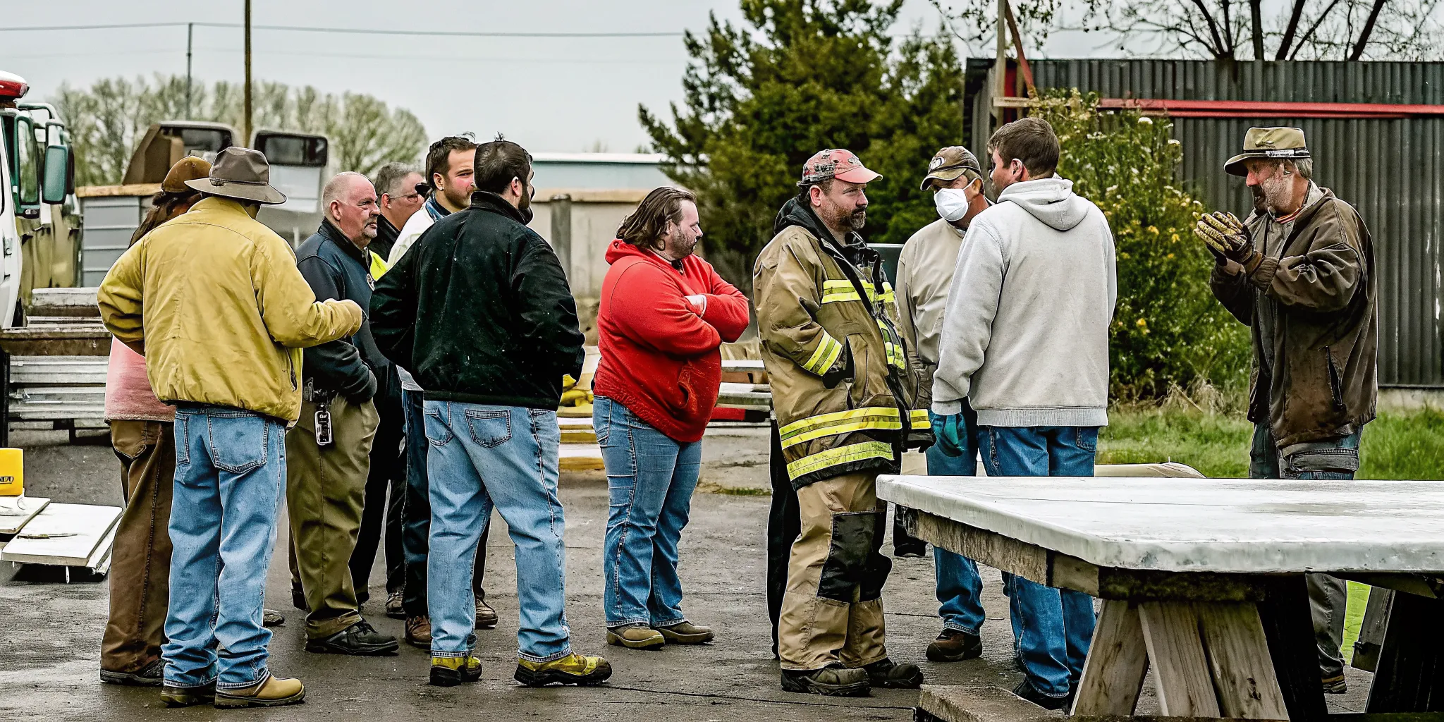 CERT team members reviewing training records and certifications on a tablet during a group coordination meeting