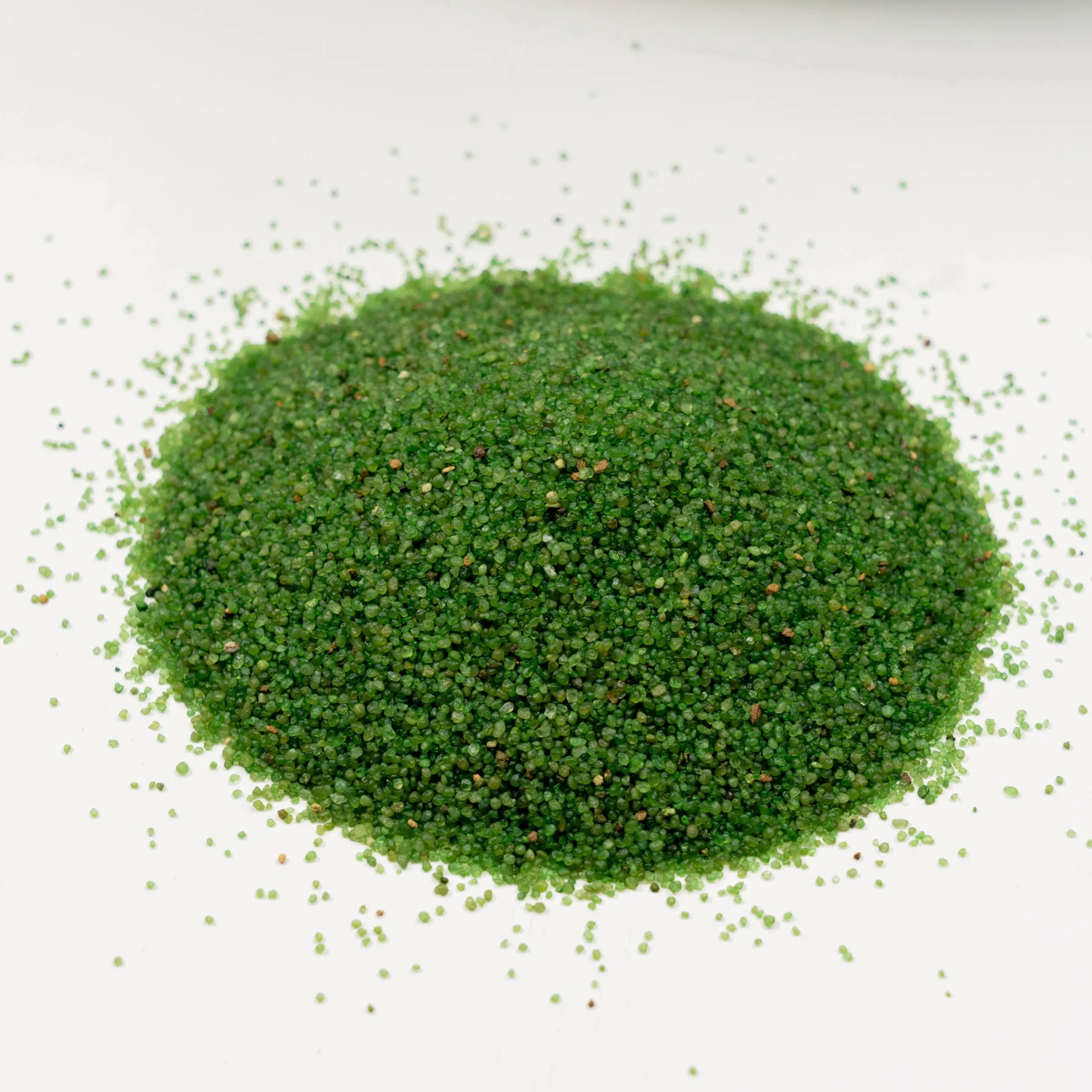 Envirofill 12-20 mesh antimicrobial turf infill granules in emerald green, showing the larger granule size ideal for residential lawns