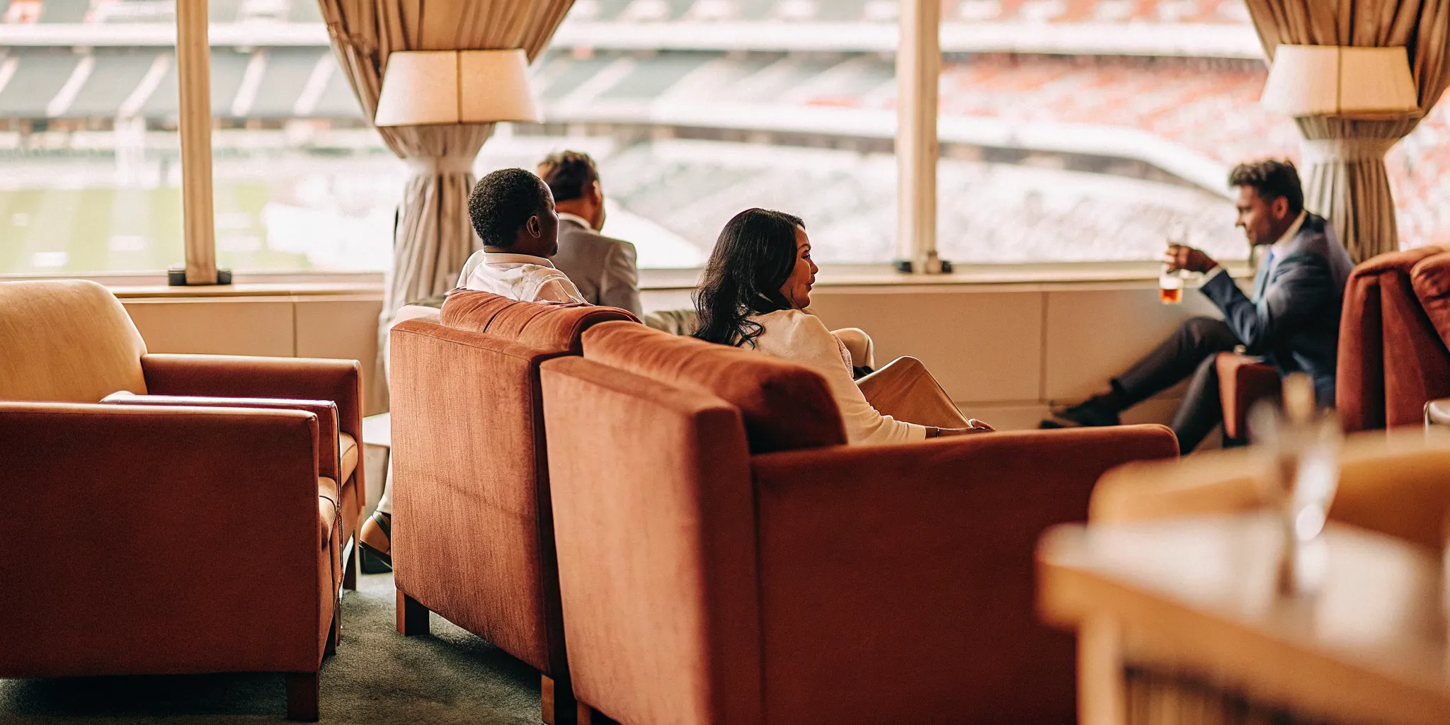 VIP corporate group enjoying a private hospitality lounge during luxury event travel