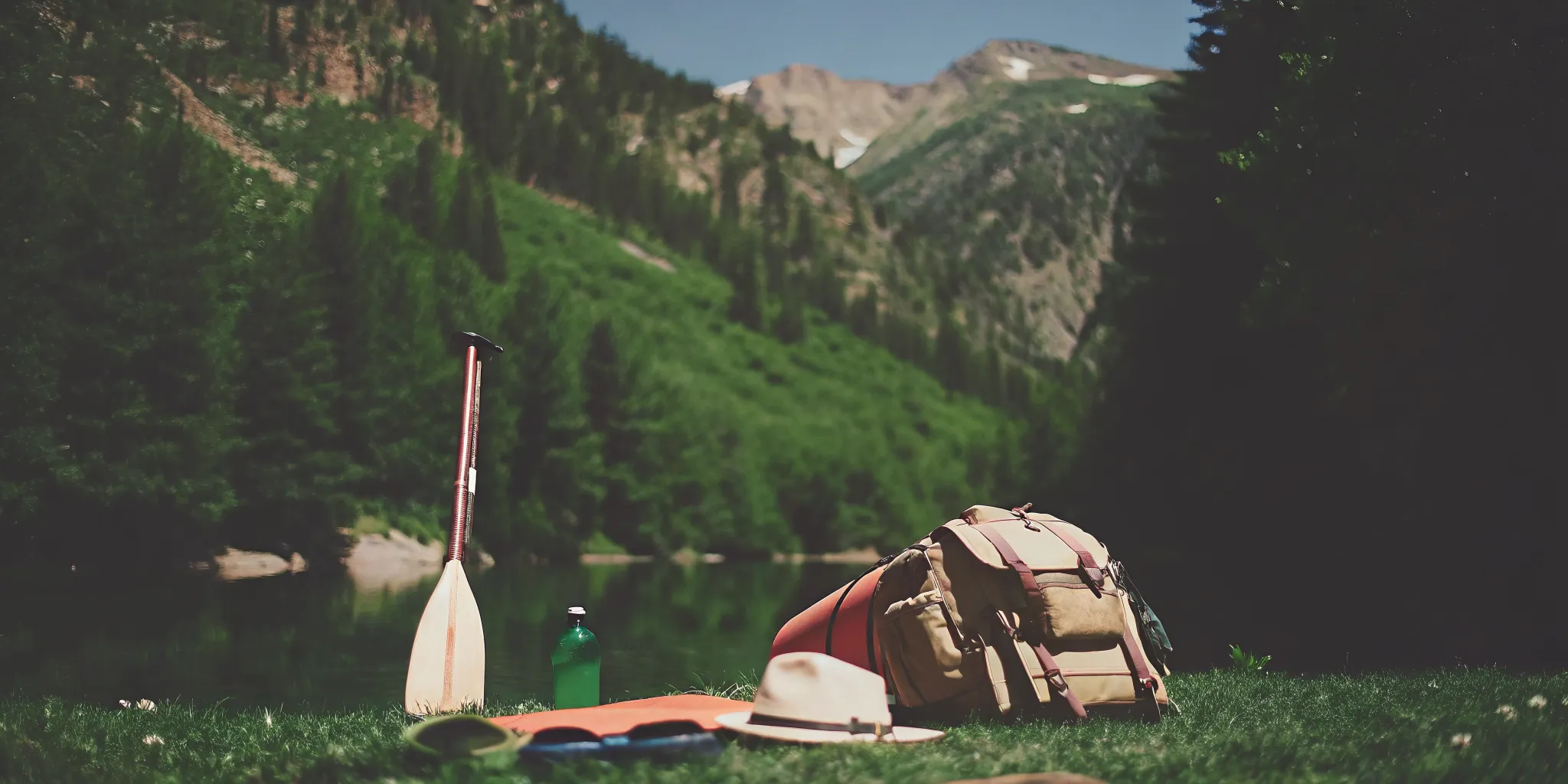 High altitude paddle boarding safety gear beside a mountain lake