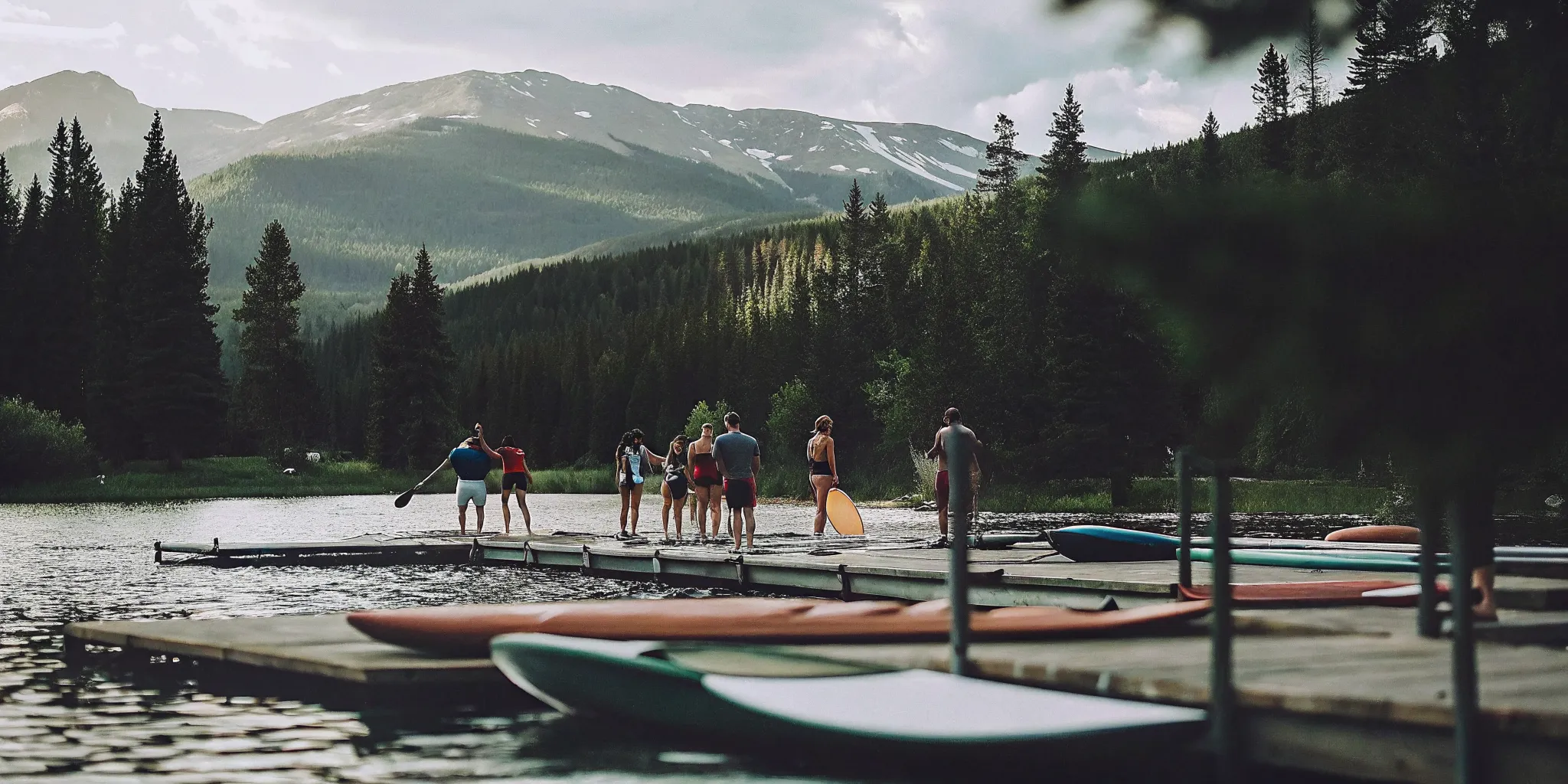 Kayaks and paddle boards at Dillon Marina dock on a sunny Colorado summer morning with mountain backdrop