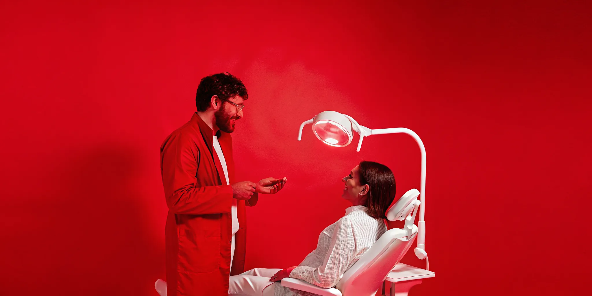 Oral surgeon consulting with patient about surgical treatment plan and insurance coverage in a modern exam room