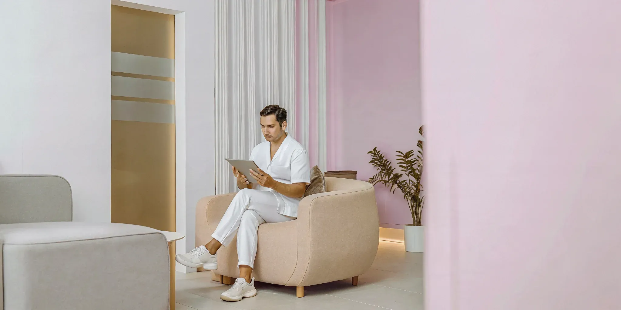 Oral surgeon planning multi-location expansion on a tablet in a modern office