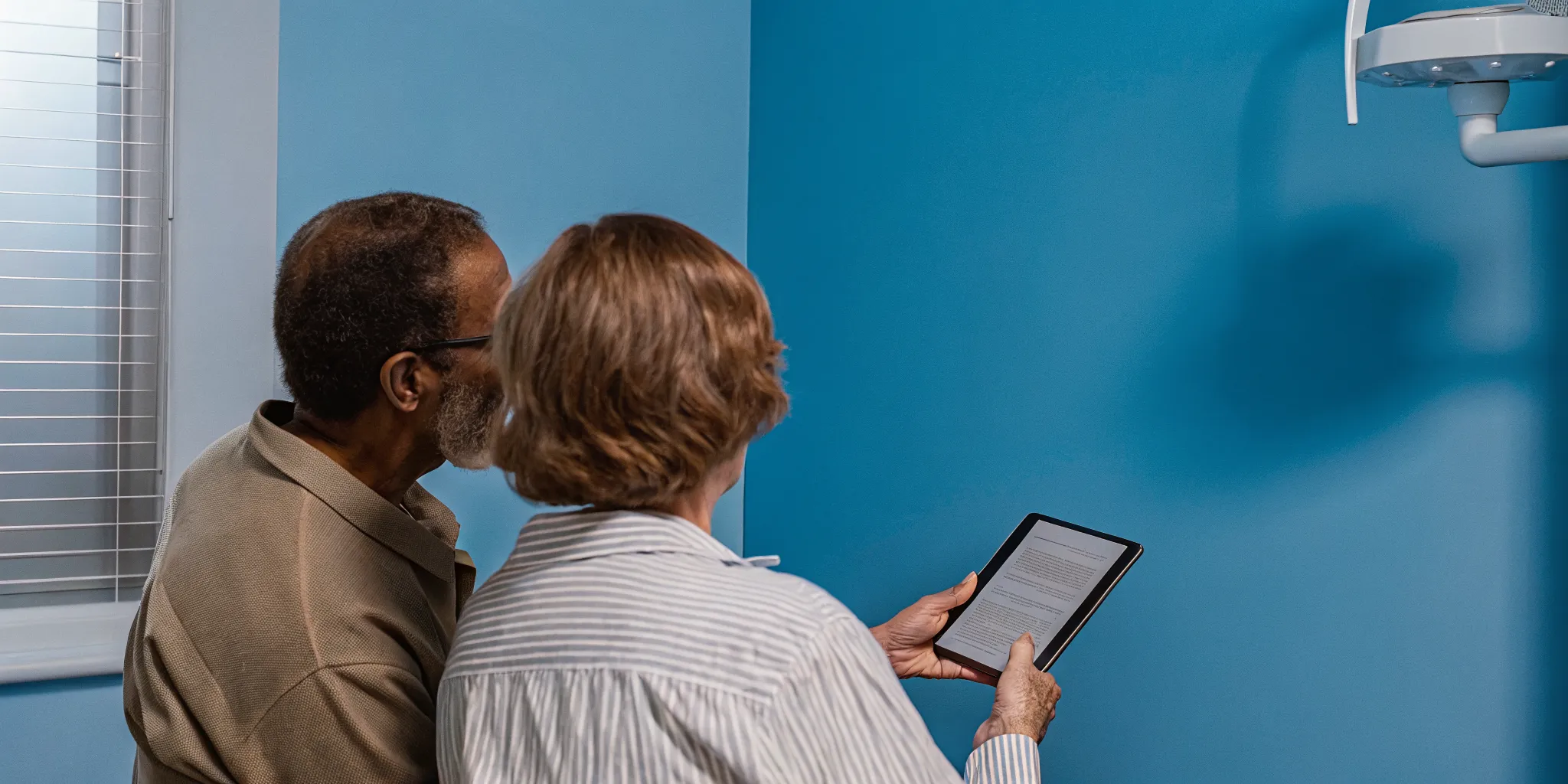 Clinician reviewing an oral surgery patient portal workflow with a patient