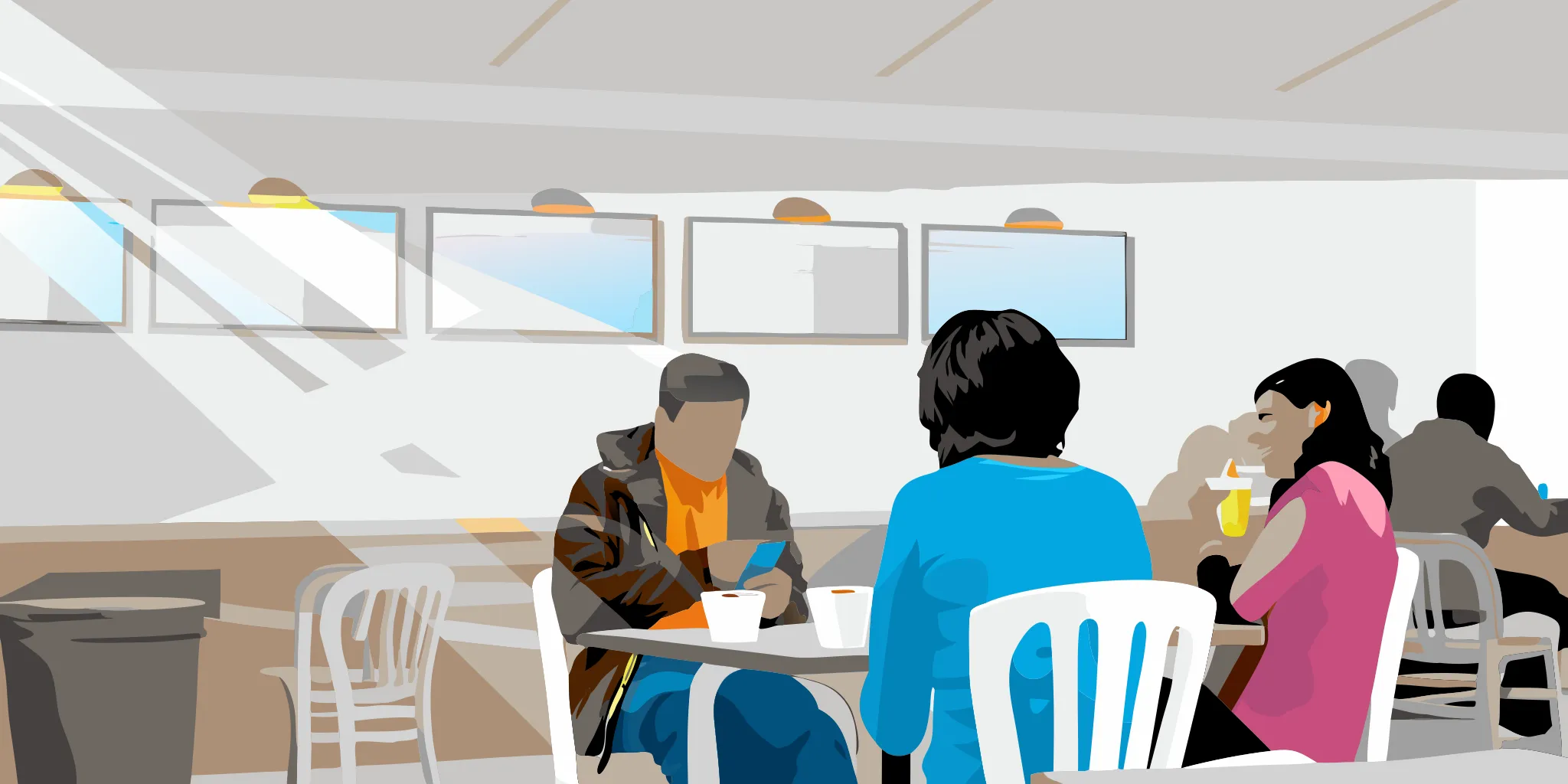 People in a coffee shop engaging with place-based advertising screens in a high-dwell venue