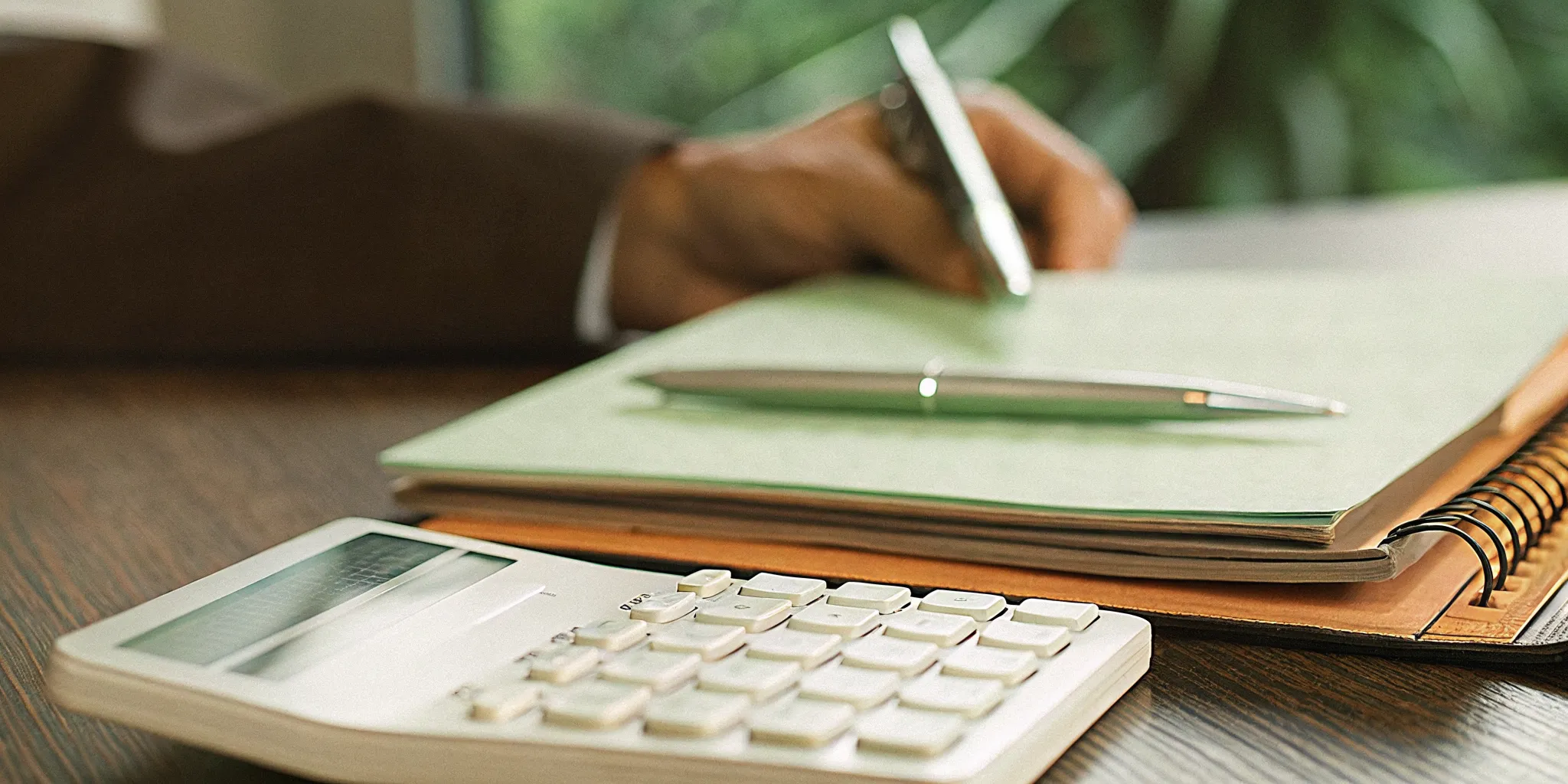 Calculator and financial papers representing business cost calculations