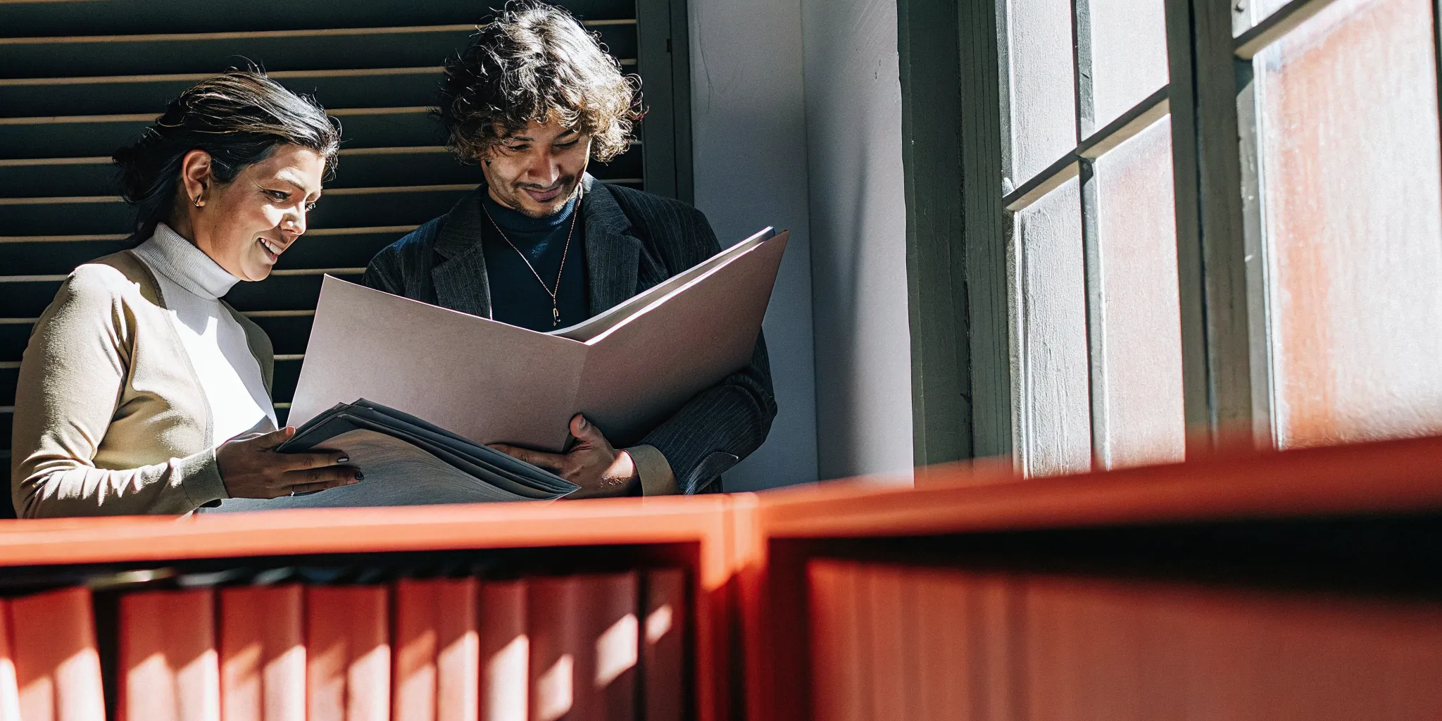 Business owner and financing specialist reviewing loan application documents