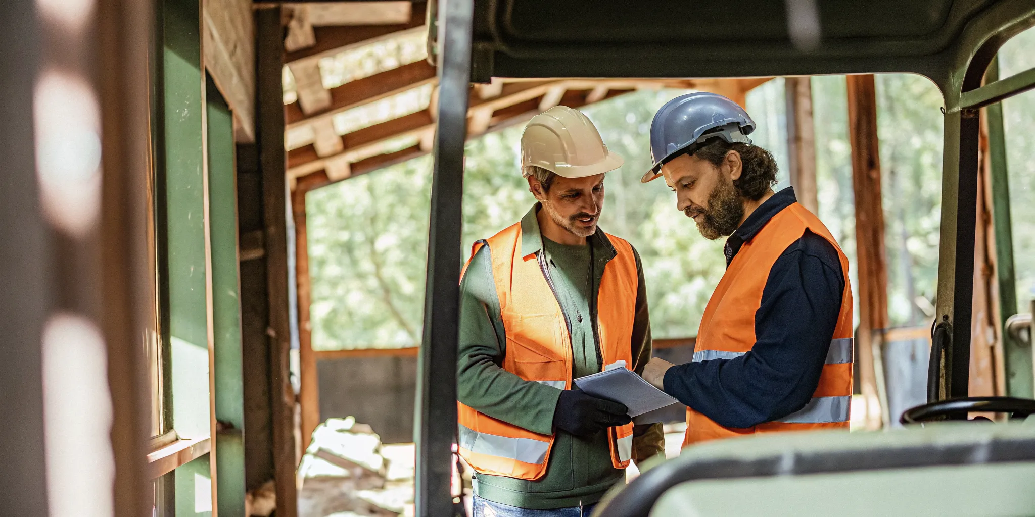 Small business owner reviewing financed construction equipment with an advisor