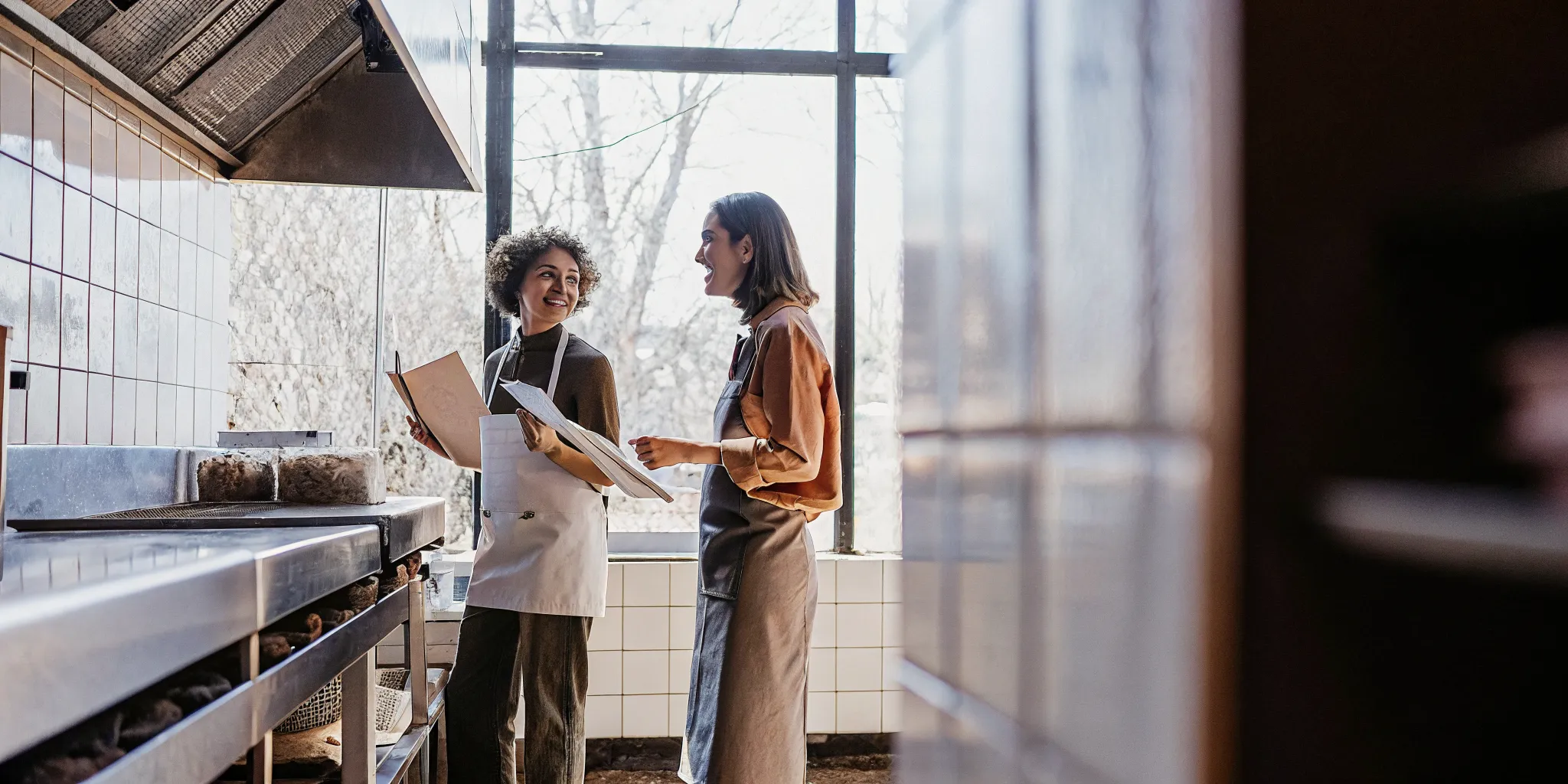 Restaurant owner and financing specialist planning a commercial equipment purchase