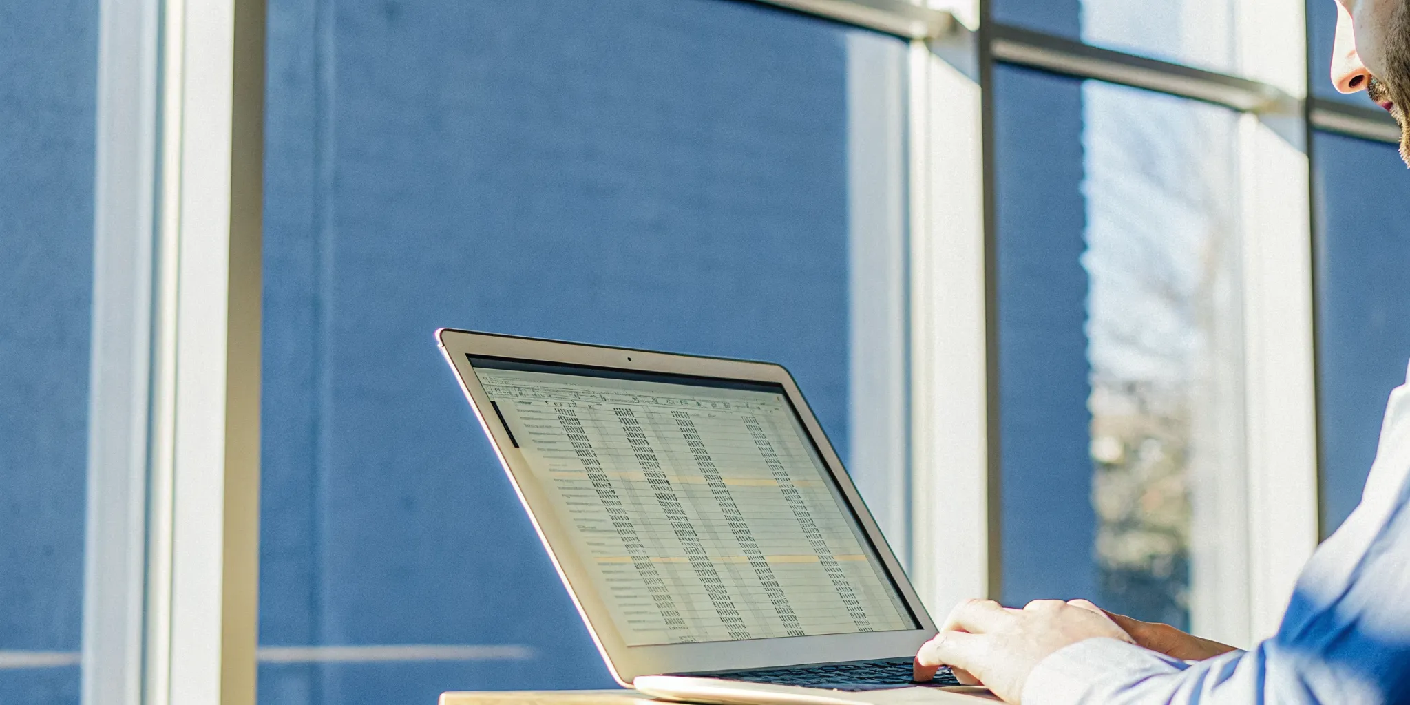 A small business owner reviewing financial documents on a laptop during the revenue based financing approval process.