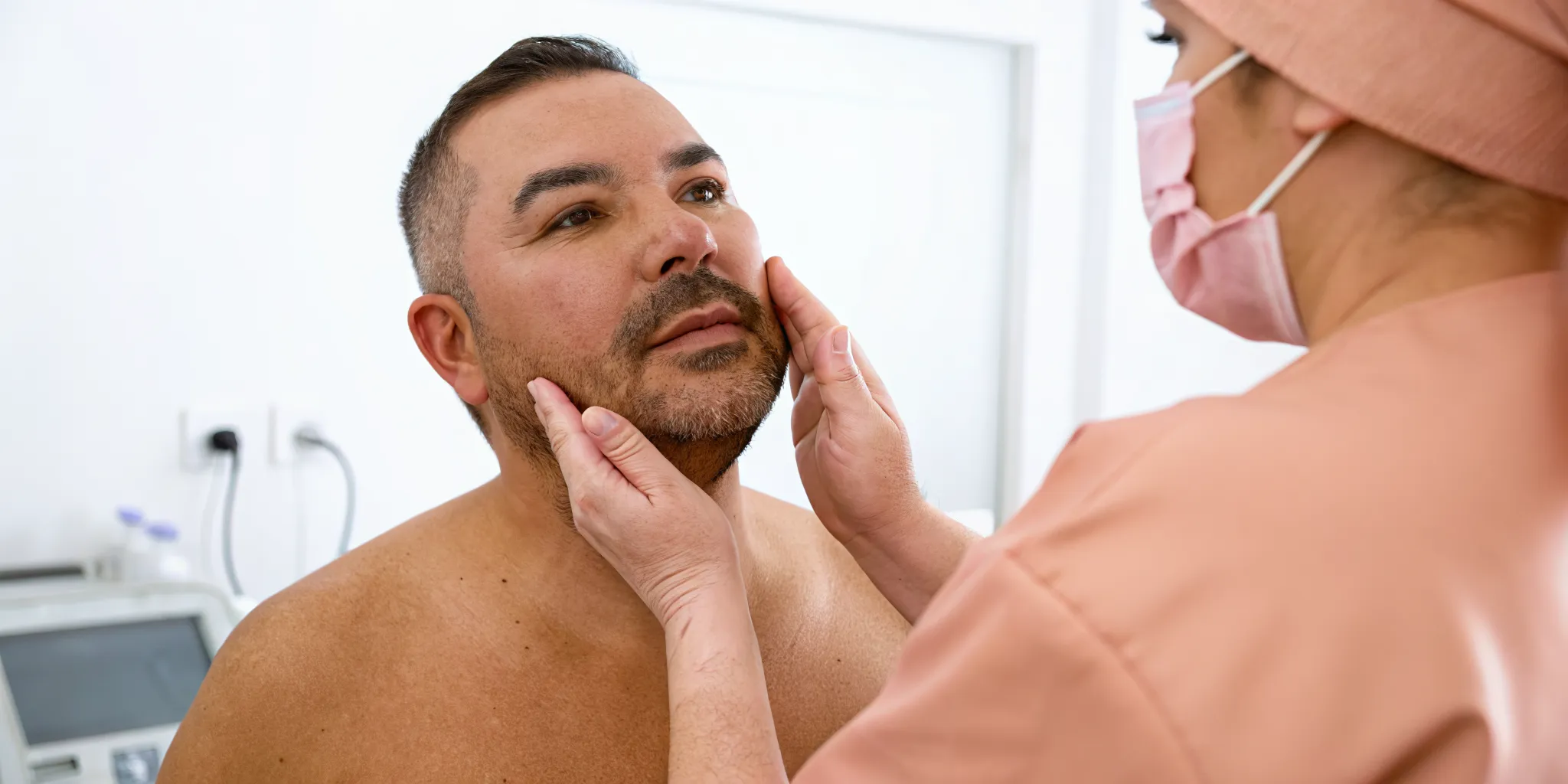 Man consulting a practitioner about microneedling for beard growth