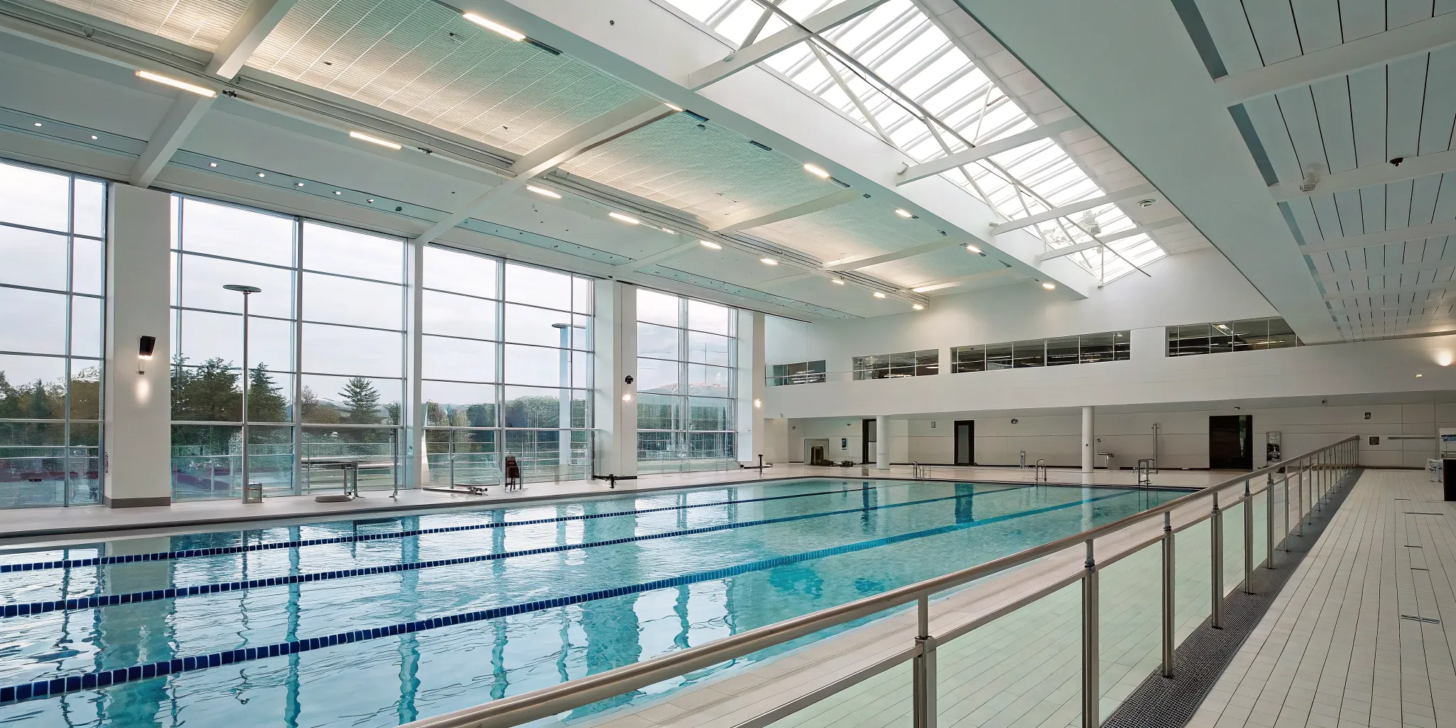 A modern swimming pool where a swimmer monitoring system works to track movement and improve safety.
