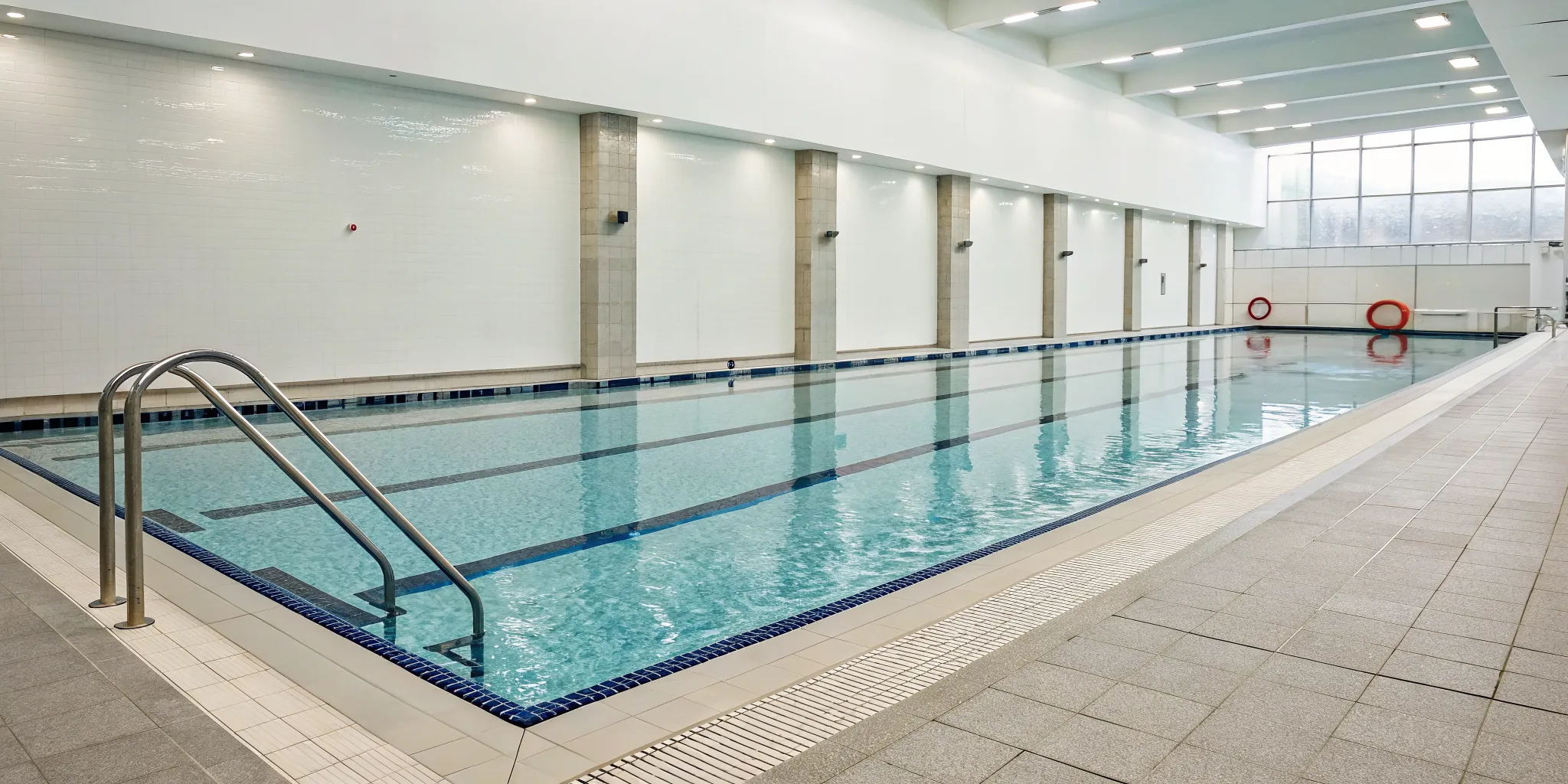 A public swimming pool with all the required safety equipment in place.