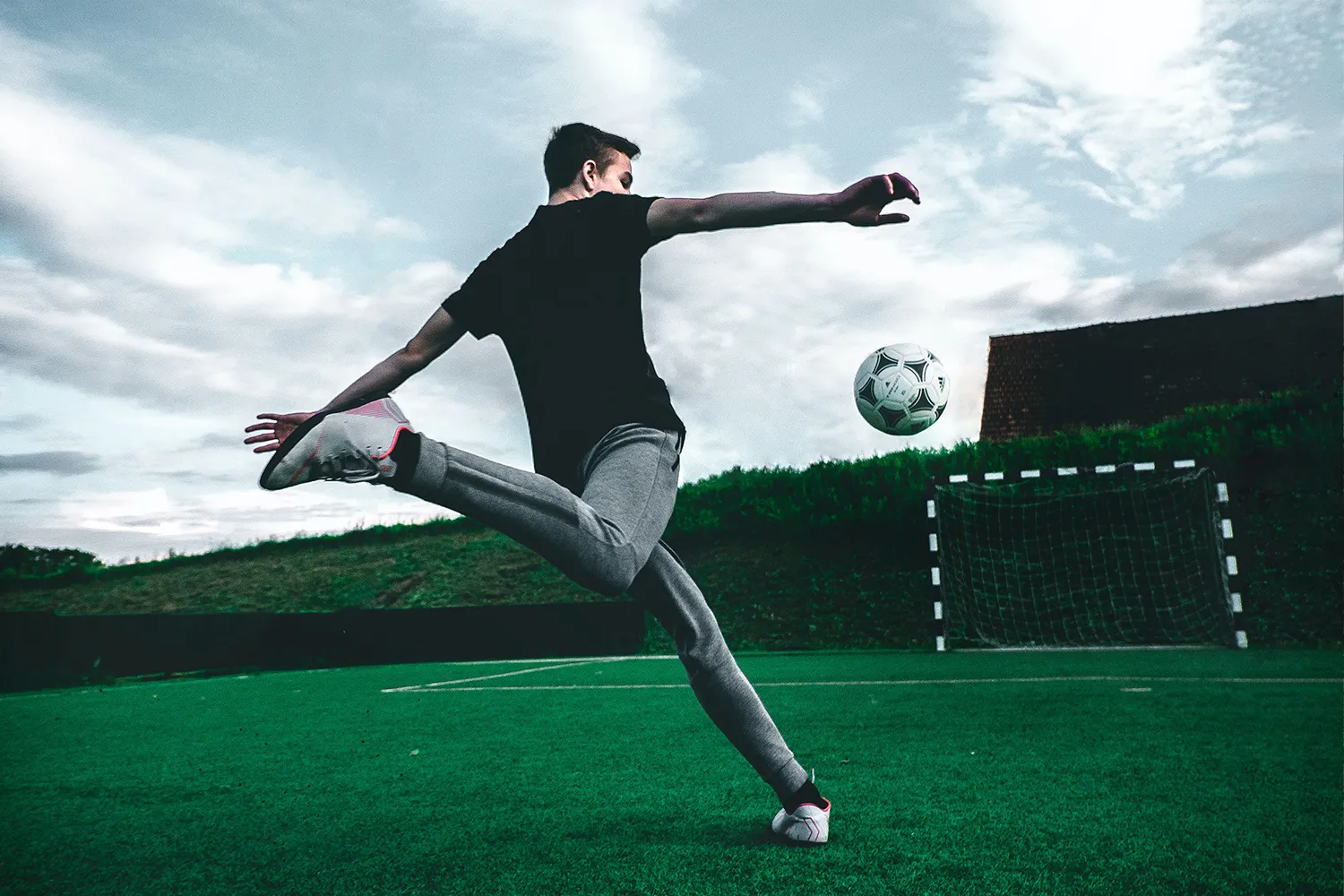 Soccer player extending a leg during an outdoor training session