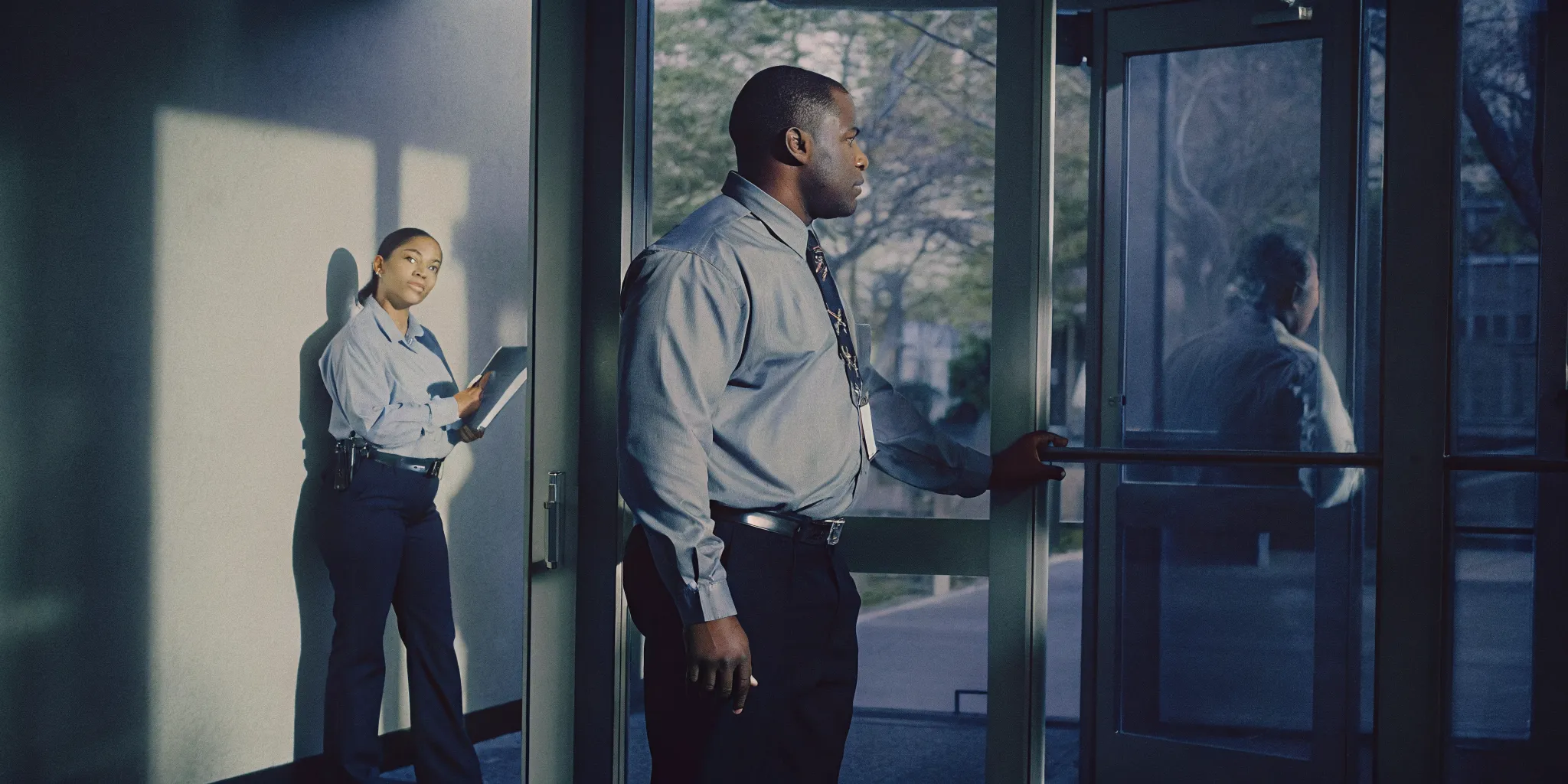 Security guard conducting a physical security audit at a San Diego commercial office building entrance