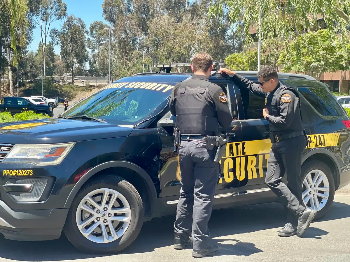 Security guard checking a visitor in at a controlled facility entrance