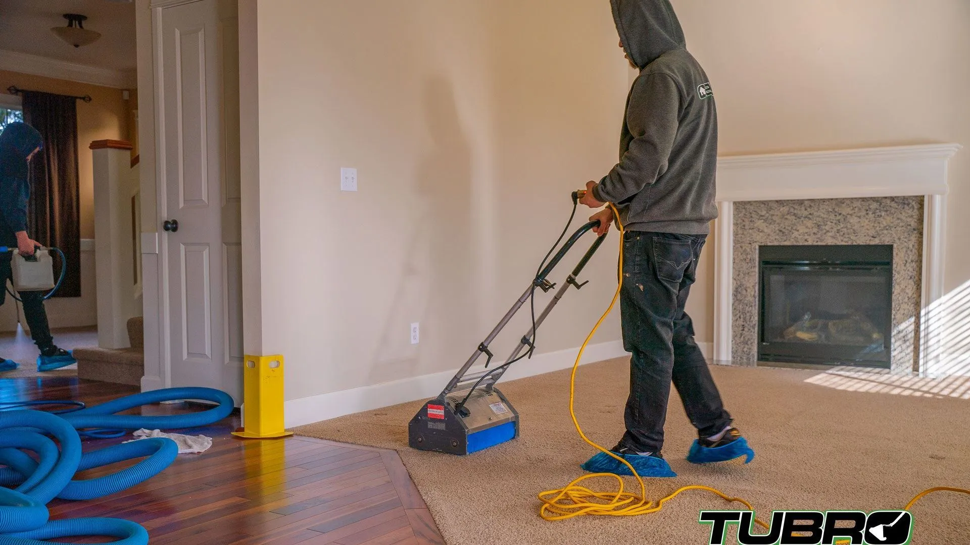 Professional carpet cleaning equipment working in a family living room