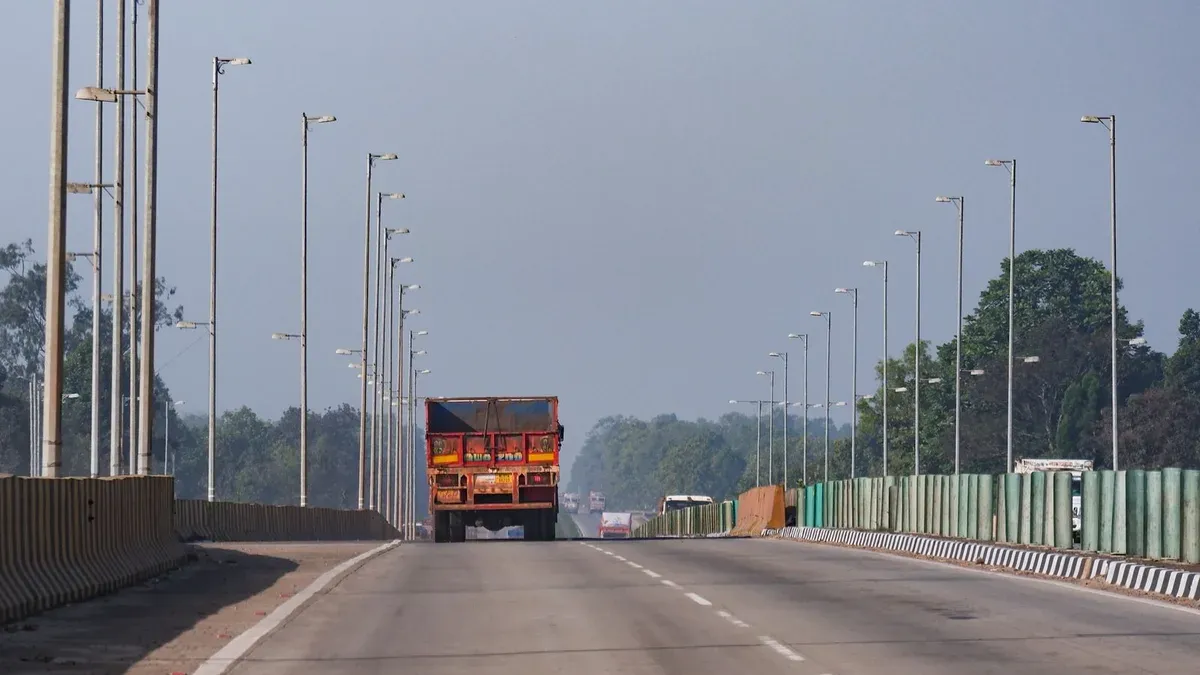 Commercial trucks and passenger vehicles traveling together on a congested highway