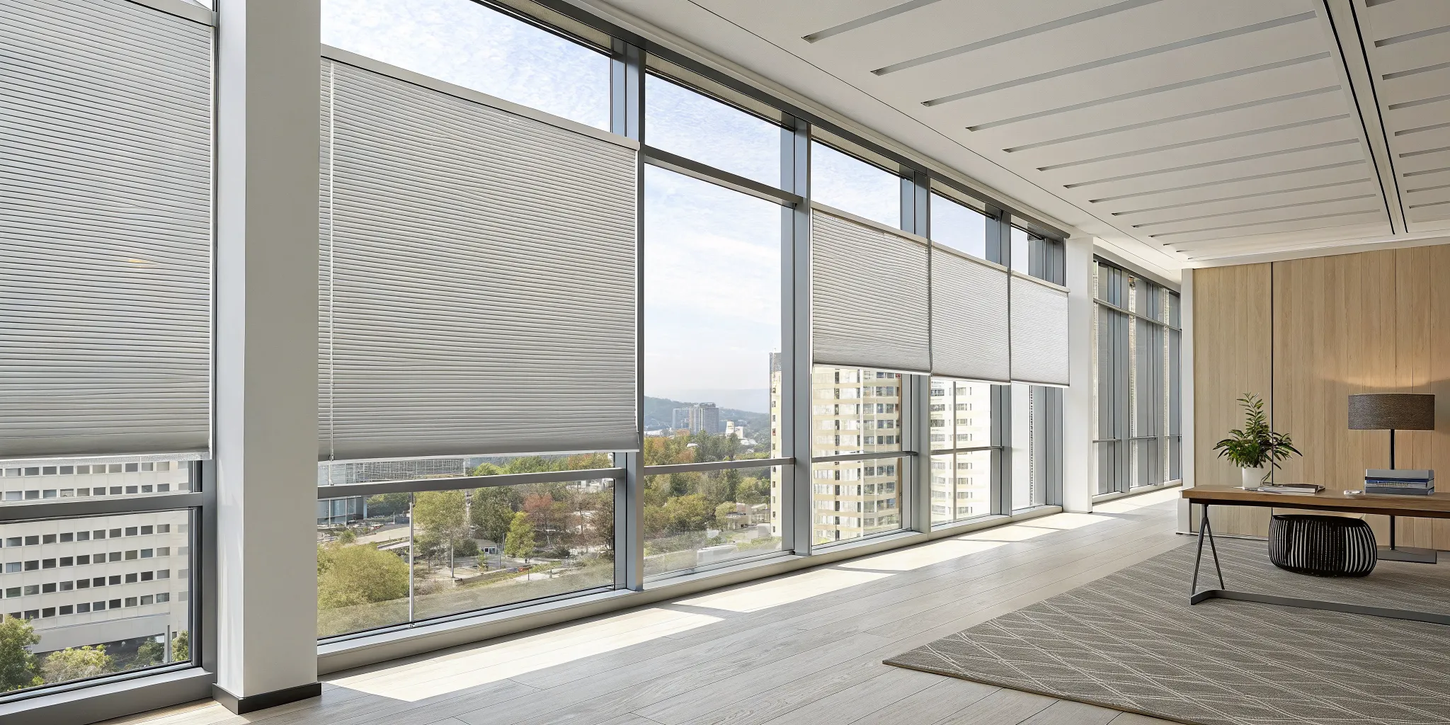 Energy-efficient honeycomb insulated blinds on large windows in a modern office.