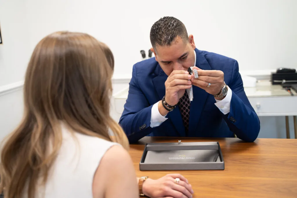 A Diamond Banc specialist handling and inspecting a fine jewelry piece during a secure evaluation