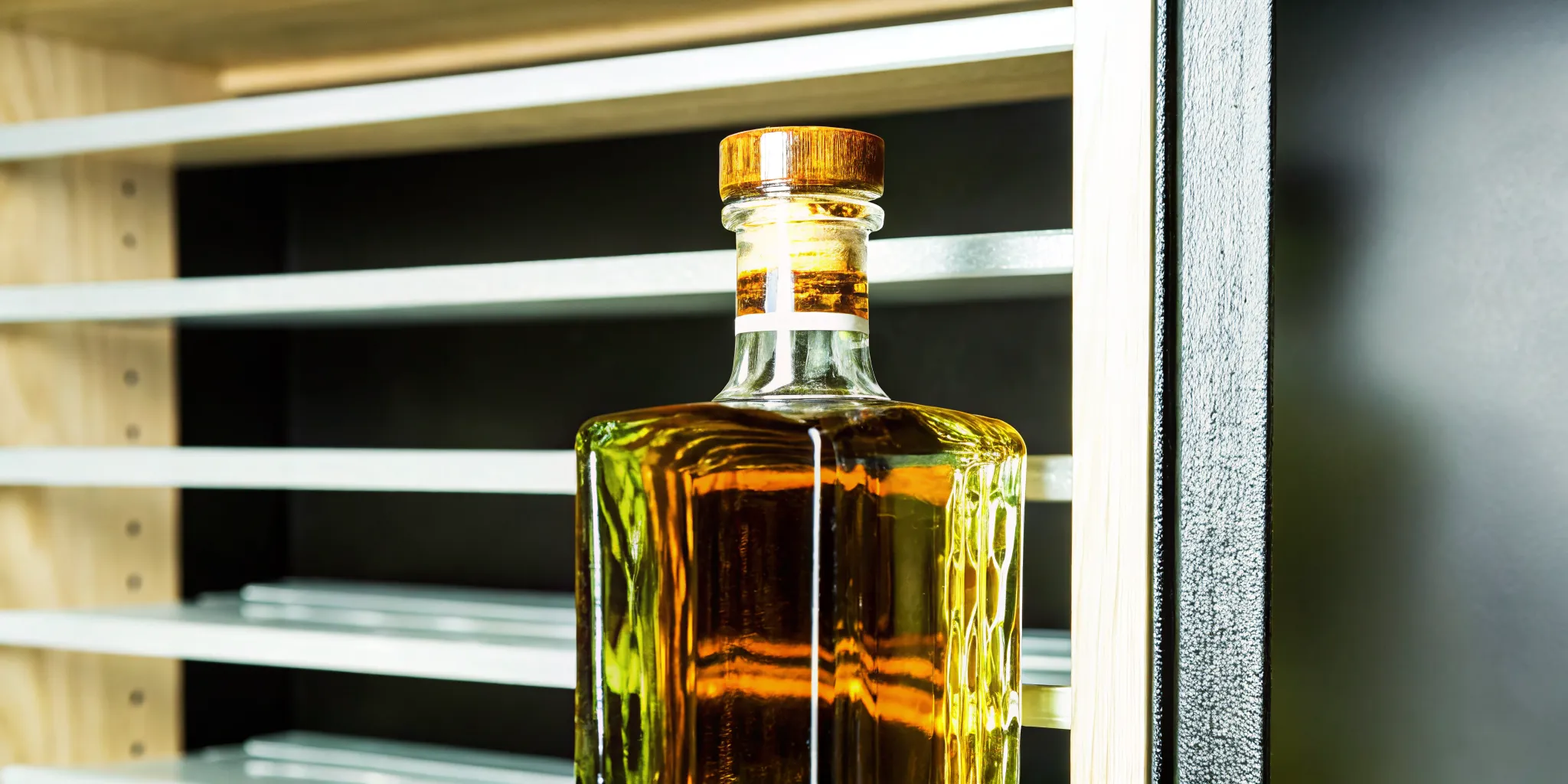 An upright bottle of premium tequila showing correct cork care and preservation