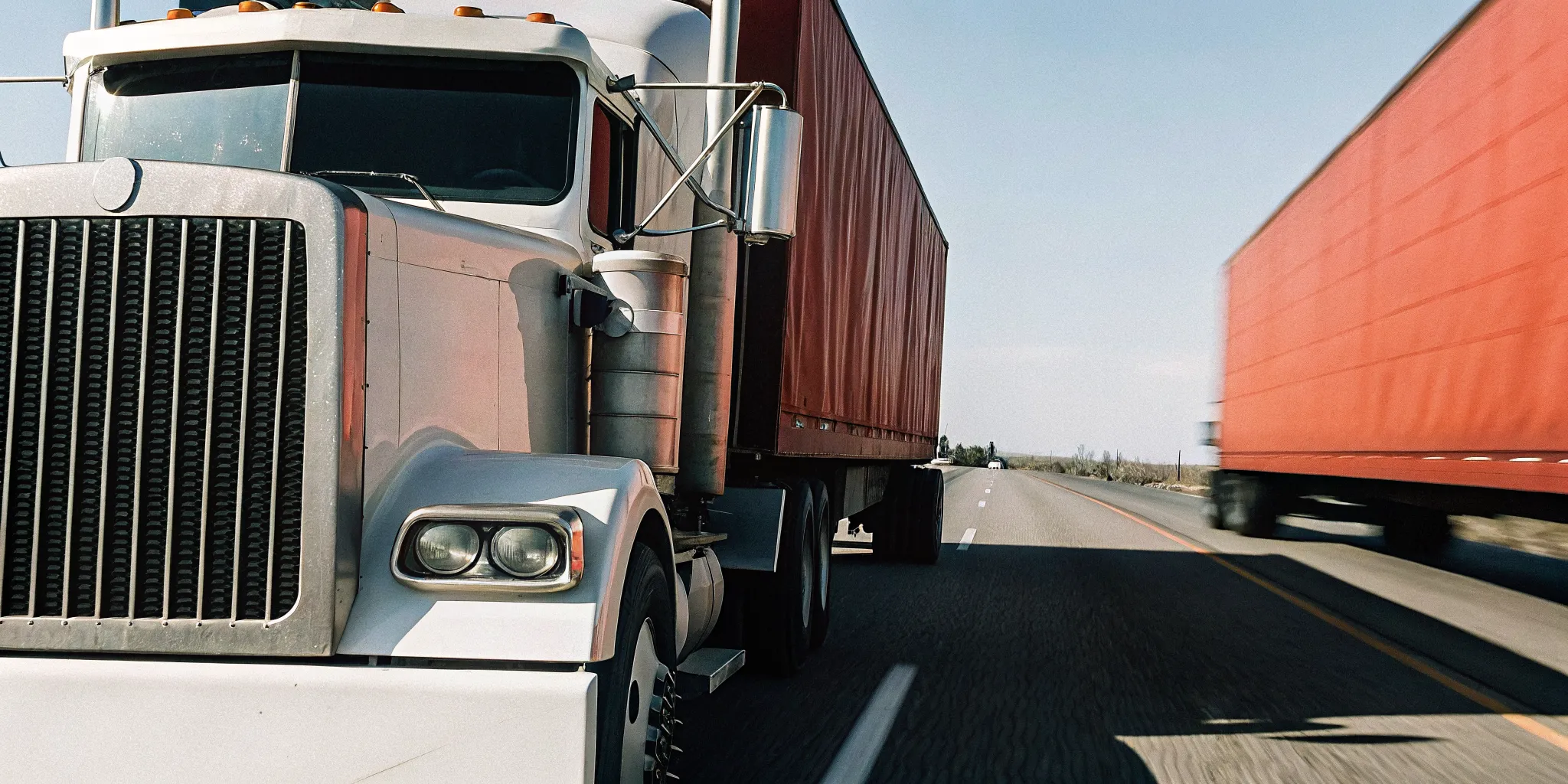Load One semi truck moving freight on an open highway, representing 3PL transportation capacity for manufacturers
