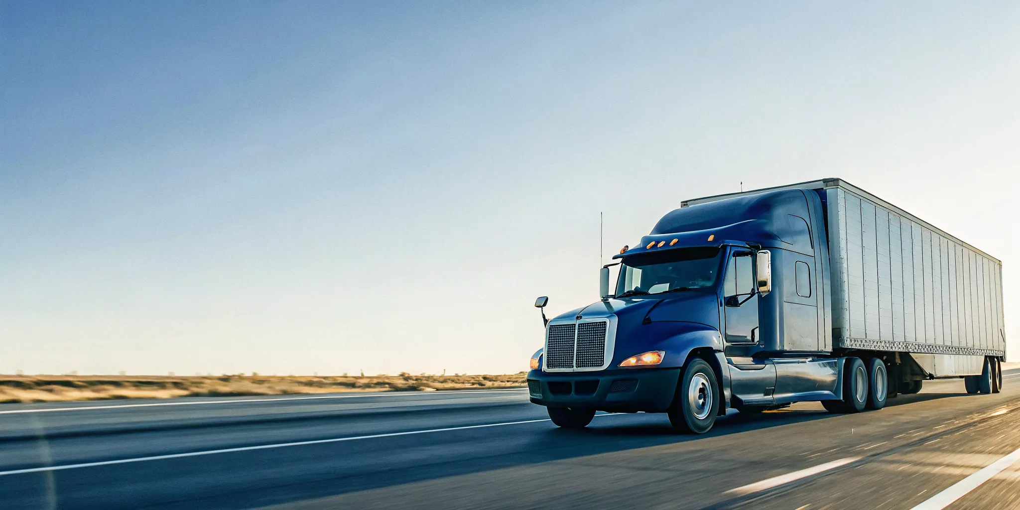 Dedicated expedite freight truck on an open highway delivering urgent parts to protect production uptime