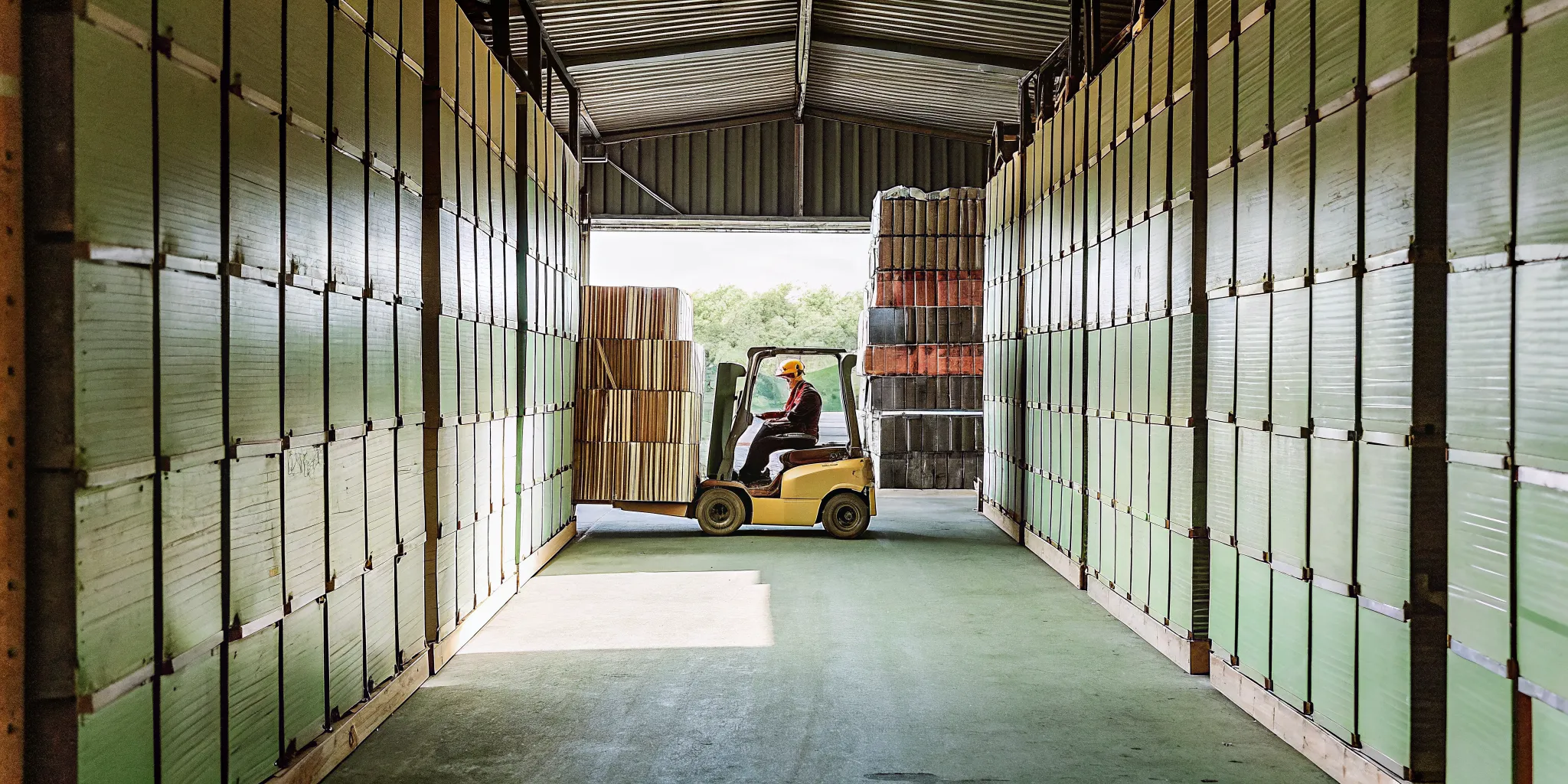 Licensed operator moving materials with a warehouse forklift