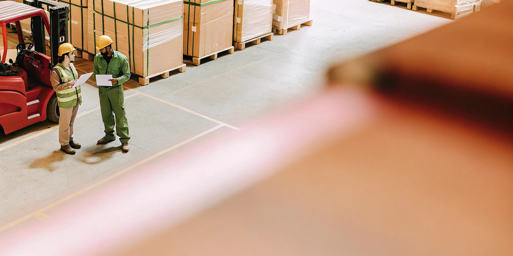 Warehouse supervisors reviewing forklift safety procedures