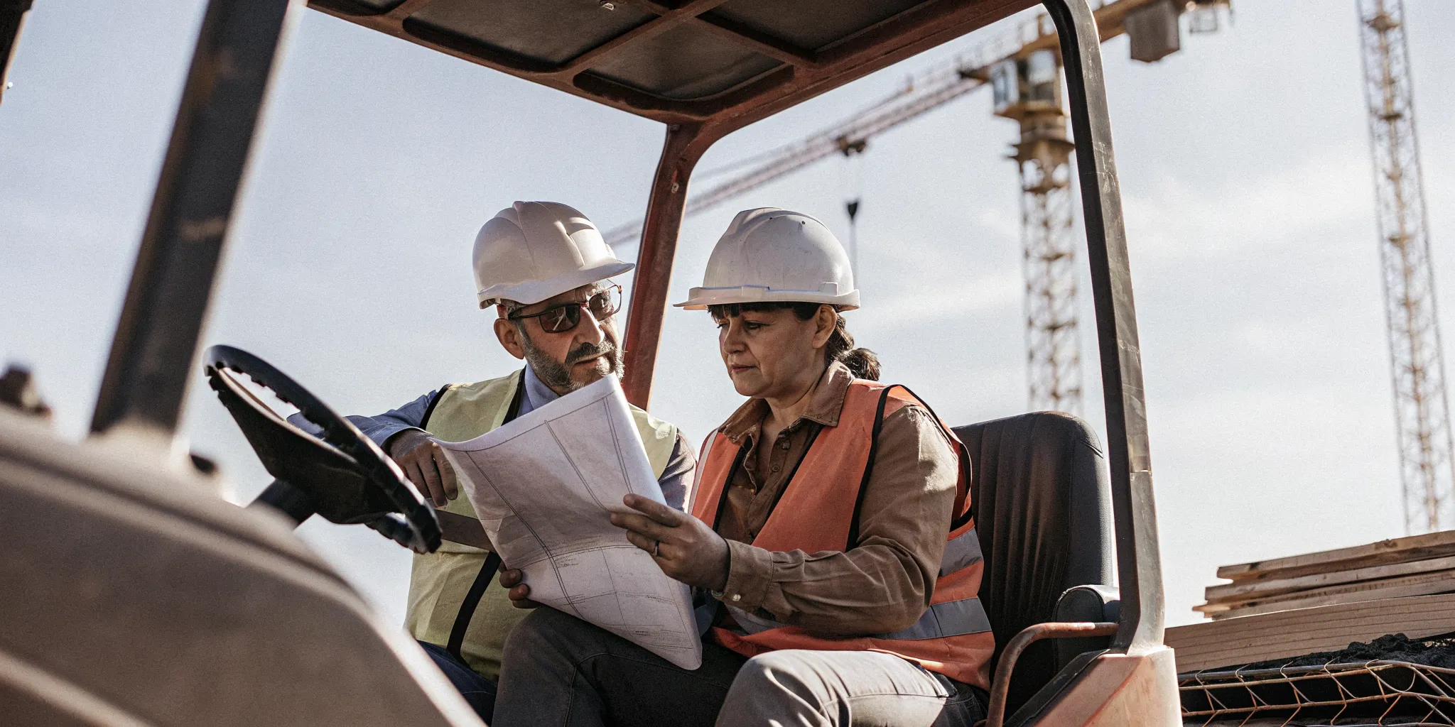Hoisting operator reviewing equipment safety procedures with an instructor