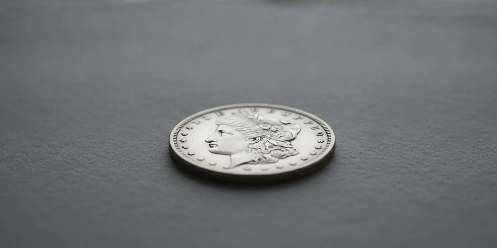 Morgan silver dollar shown obverse side up on a neutral collector's surface