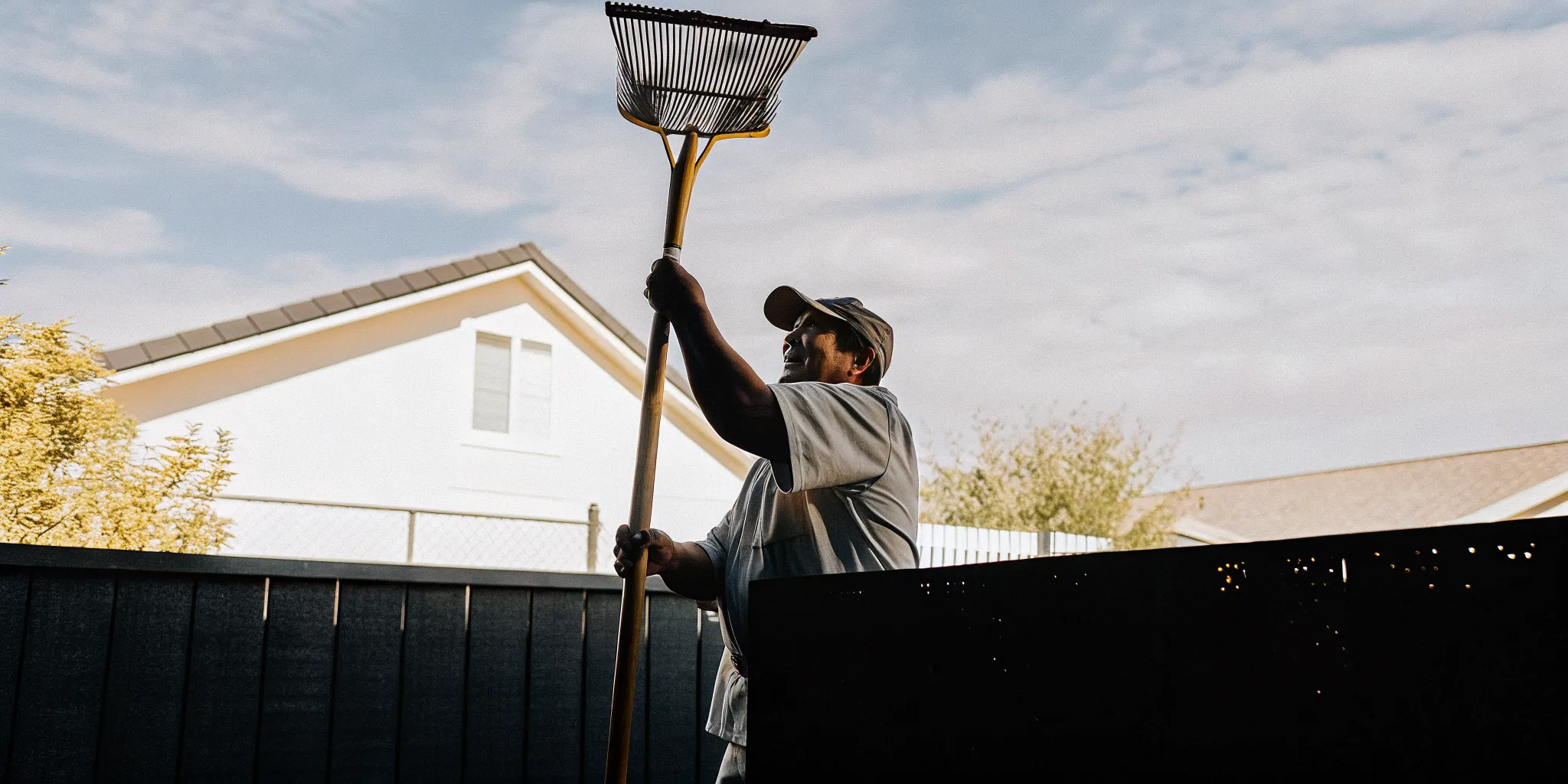 Trusted Las Vegas pooper scooper service technician clearing a clean backyard with professional pet waste equipment
