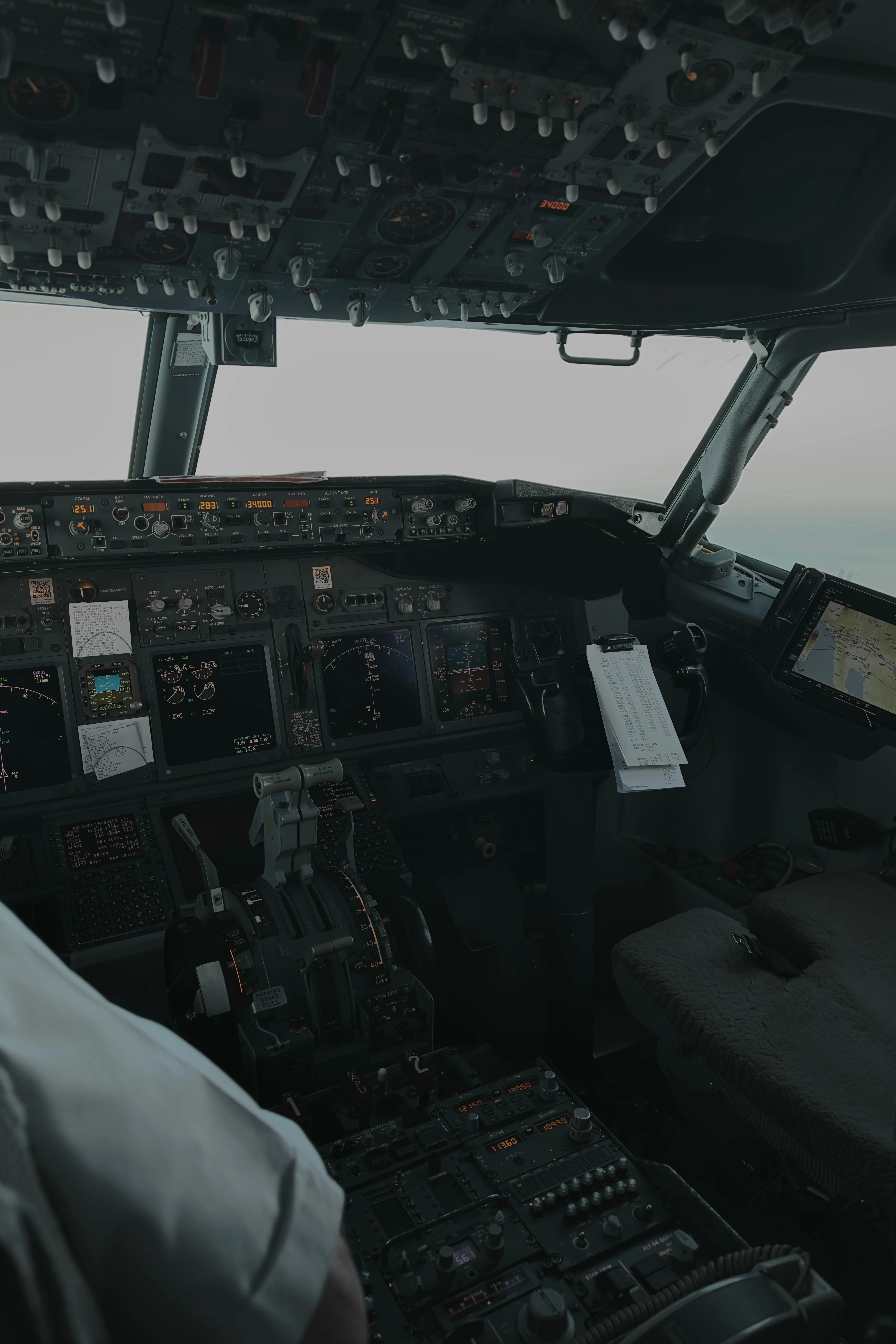 Commercial aircraft cockpit interior with flight instruments, controls, and navigation displays