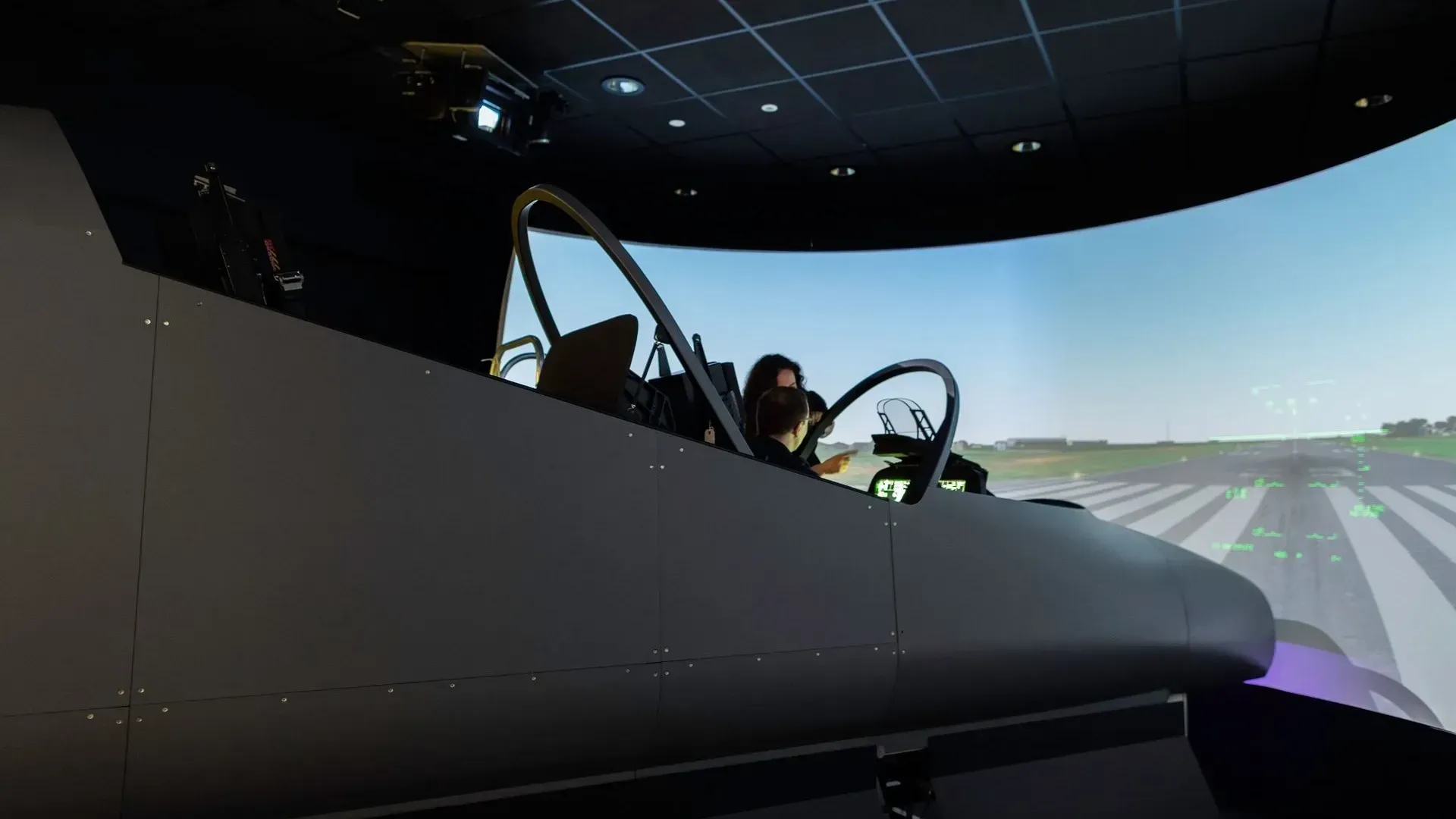 Two pilots working together in a cockpit during professional flight training