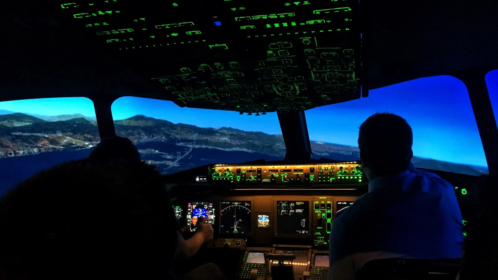 Pilots working inside a real cockpit simulator during professional training