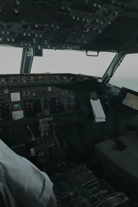 Modern aircraft cockpit with digital flight displays and center pedestal controls